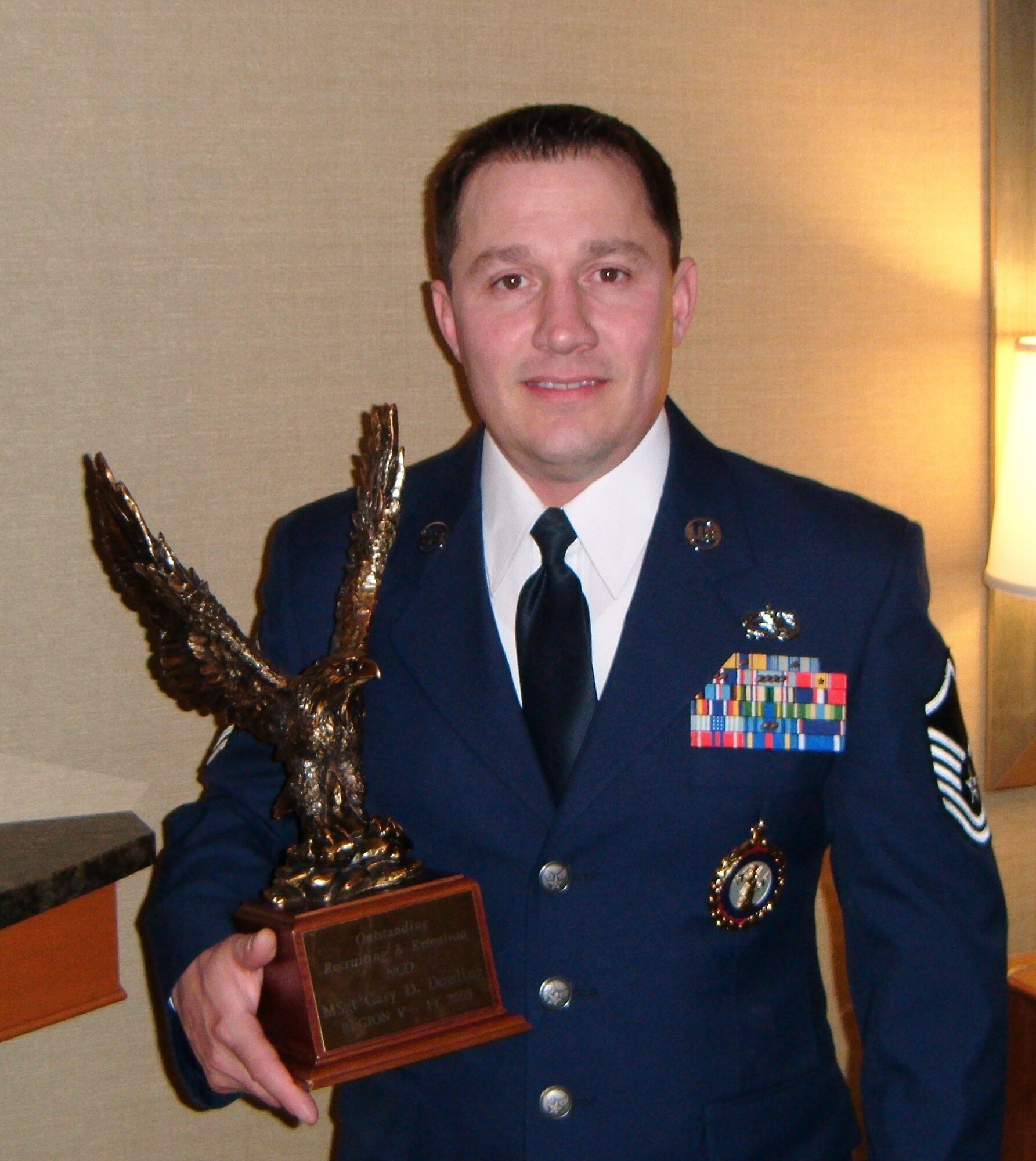 Master Sgt. Gary Dowling displays the trophy he received during a recruiting and retention workshop  awards banquet in Dallas Feb. 22, 2010.  Dowling was named Recruiting/Retention Noncommissioned Officer of the Year. (Photo courtesy of Master Sgt. Gary Dowling)