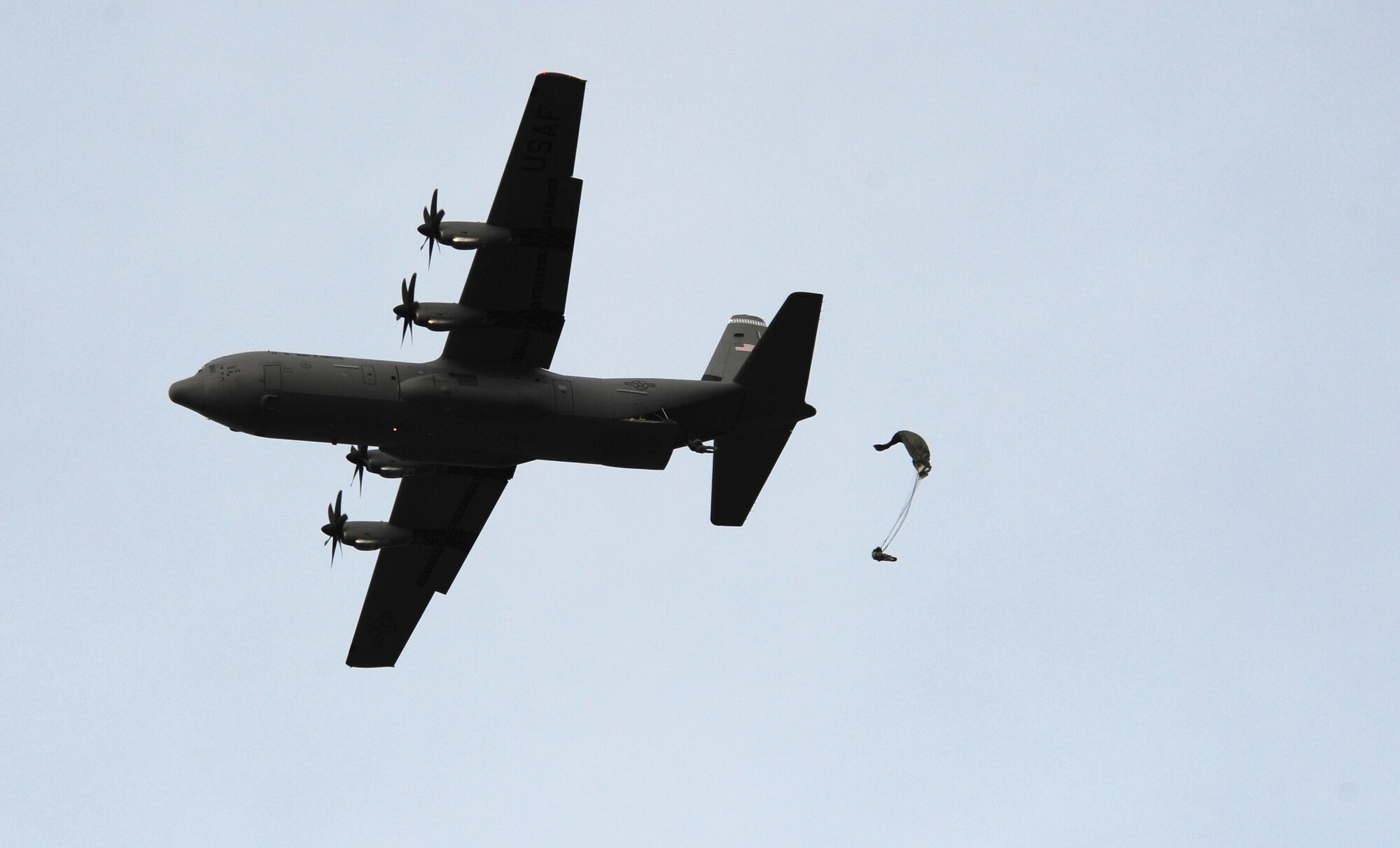 U.S. and French paratroopers exit a U.S. Air Force C-130J under U.S. military parachutes in a multi nation jump, March 2, 2010.  Members of the 435th Contingency Response Group and the 5th Quartermaster Company joined with their French military counterparts for a week of training at the École des troupes aéroportées (ETAP), or School of Airborne Troops, a military school dedicated to training the military paratroopers   of the French army, located in the town of Pau, in the département  of Pyrénées-Atlantiques, France.  The ETAP is responsible for training paratroopers, and for international cooperation and promotion of paratroop culture. (U.S. Air Force Photo by Staff Sgt. Jocelyn Rich)