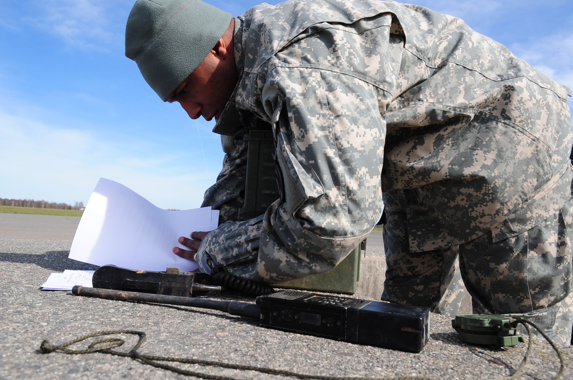U.S. Army Chief Warrent Officer Pharel Petifrere establishes communications and documents weather conditions on the drop zone of a mutinational jump with U.S. and French paratroopers on March 2, 2010.  Members of the 435th Contingency Response Group and the 5th Quartermaster Company joined with their French military counterparts for a week of training at the École des troupes aéroportées (ETAP), or School of Airborne Troops, a military school dedicated to training the military paratroopers   of the French army, located in the town of Pau, in the département  of Pyrénées-Atlantiques , France.  The ETAP is responsible for training paratroopers, and for international cooperation and promotion of paratroop culture. (U.S. Air Force Photo by Staff Sgt. Jocelyn Rich)