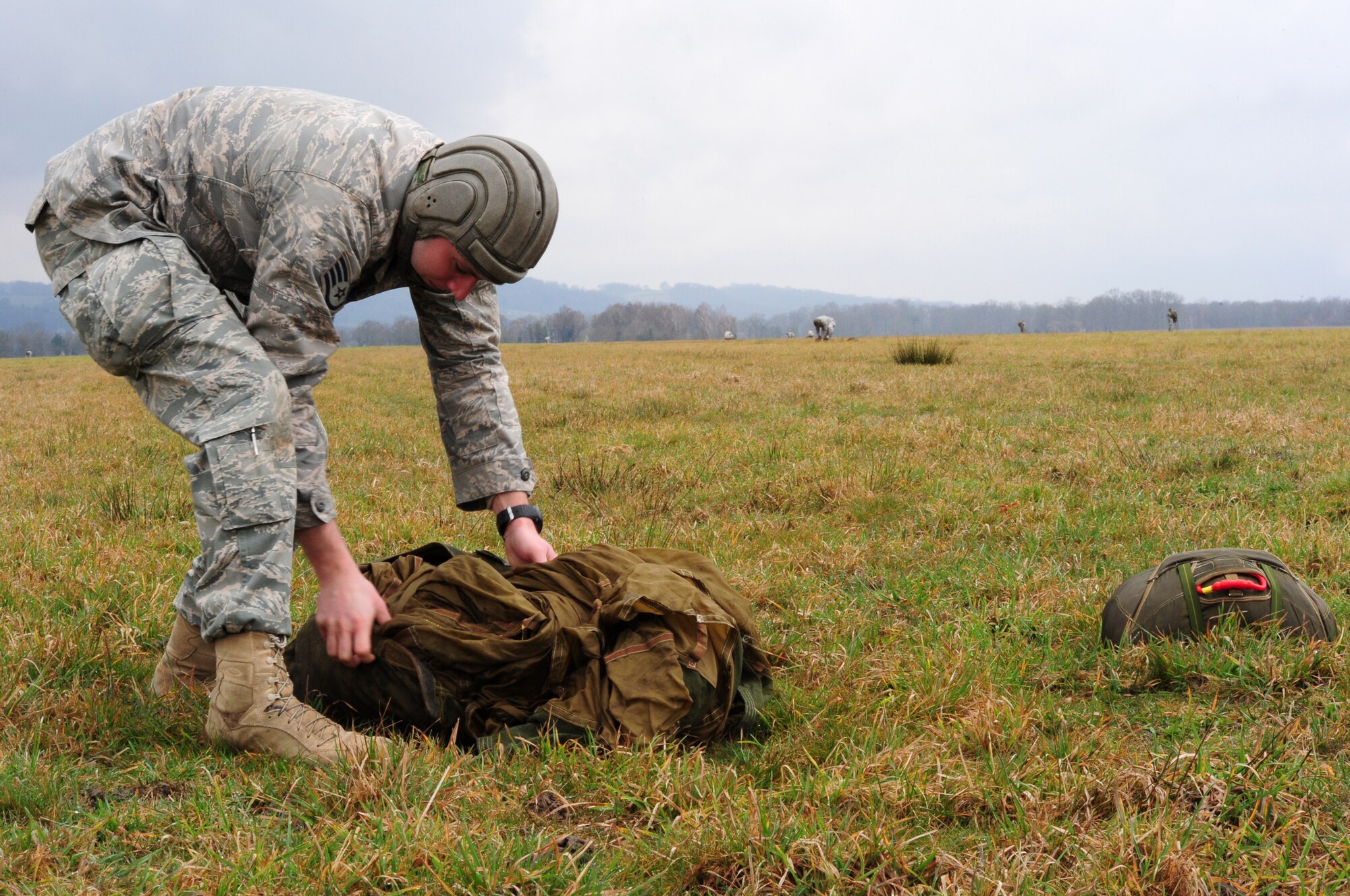 U.S. Air Force Staff Sgt. Derrick Drennan collects his French military parachute after a multinational jump, March 4, 2010.  Members of the 435th Contingency Response Group and the 5th Quartermaster Company joined with their French military counterparts for a week of training at the École des troupes aéroportées (ETAP), or School of Airborne Troops, a military school dedicated to training the military paratroopers   of the French army, located in the town of Pau, in the département  of Pyrénées-Atlantiques , France.  The ETAP is responsible for training paratroopers, and for international cooperation and promotion of paratroop culture. (U.S. Air Force Photo by Staff Sgt. Jocelyn Rich)