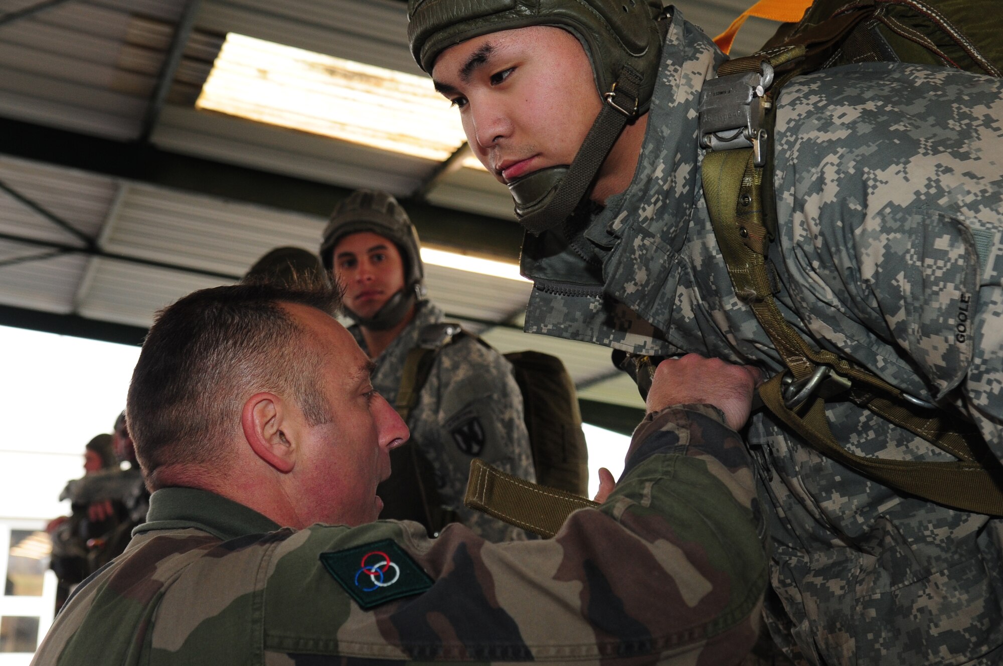 French Airborne Academy instructor Master Sgt. Stephane Paternotte inspects a French military parachute worn by U.S. Army Specialist Ryan Goole just before a multinational jump with U.S. and French military members, March 4, 2010.  Members of the 435th Contingency Response Group and the 5th Quartermaster Company joined with their French military counterparts for a week of training at the École des troupes aéroportées (ETAP), or School of Airborne Troops, a military school dedicated to training the military paratroopers   of the French army, located in the town of Pau, in the département  of Pyrénées-Atlantiques , France.  The ETAP is responsible for training paratroopers, and for international cooperation and promotion of paratroop culture. (U.S. Air Force Photo by Staff Sgt. Jocelyn Rich)