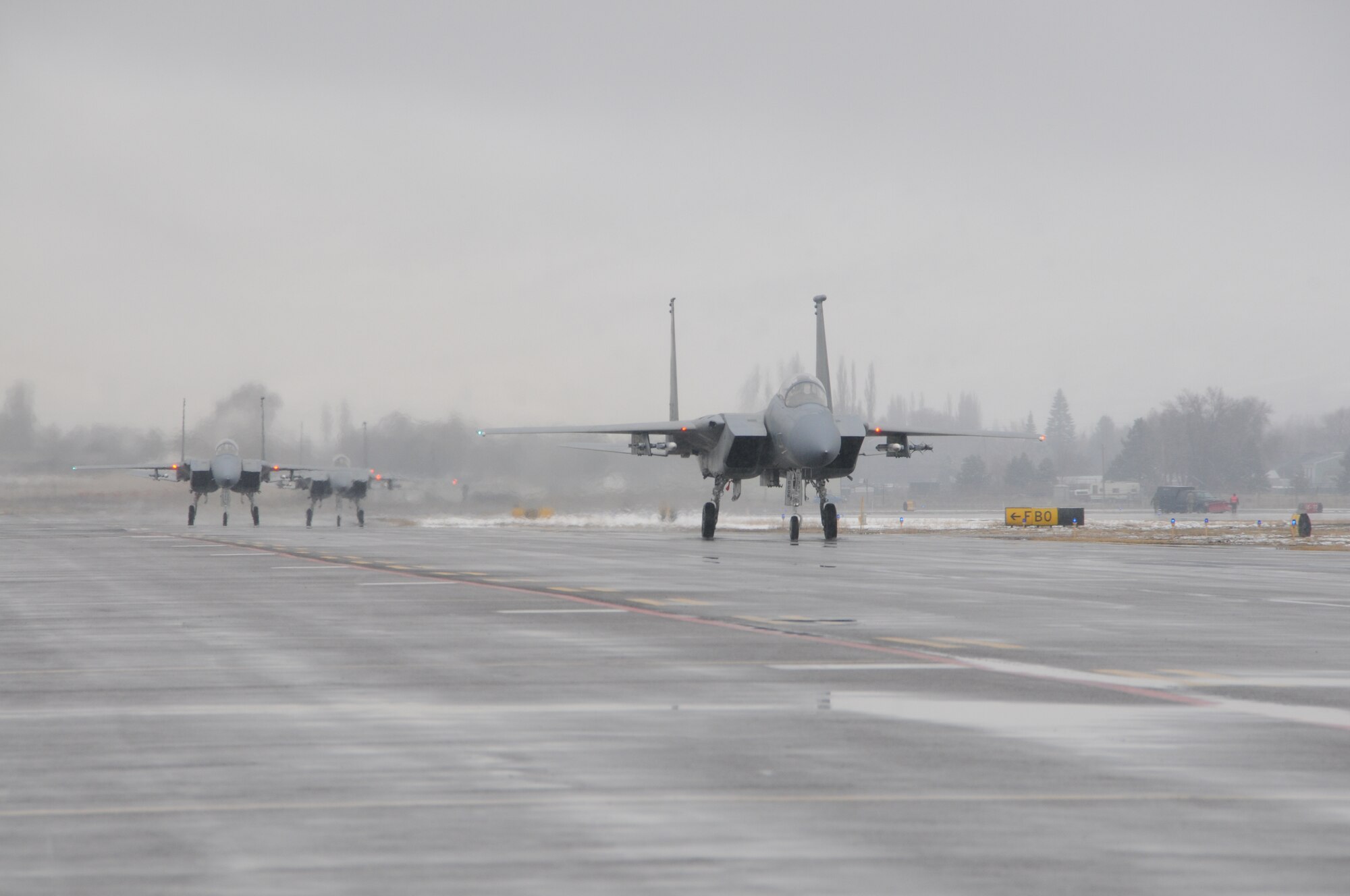 Three Ore. Air National Guard F-15 Eagles from the 173rd Fighter Wing taxi down the snowy flightline at Kingsley Field, Klamath Falls, Ore. February 2, 2010. The completion of this routine training mission marked 100,000 hours flown by the 114th Squadron since its inception in 1983, a truly significant milestone. (U.S. Air Force photo by Tech. Sgt. Jennifer Shirar, Released)  
