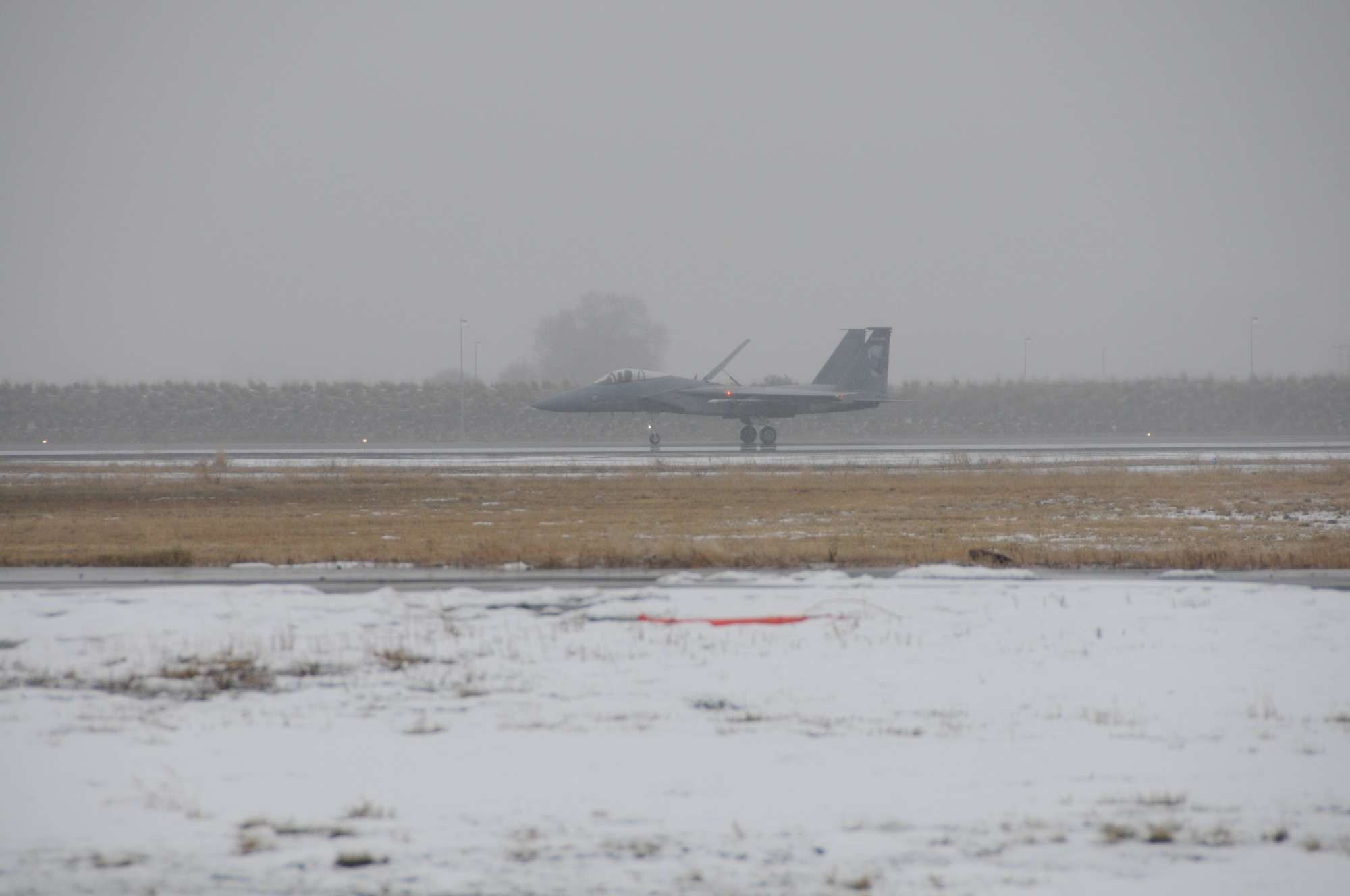 An Ore. Air National Guard F-15 Eagle from the 173rd Fighter Wing lands on the snowy runway at Kingsley Field, Klamath Falls, Ore. February 2, 2010. The completion of this routine training mission marked 100,000 hours flown by the 114th Squadron since its inception in 1983, a truly significant milestone. (U.S. Air Force photo by Tech. Sgt. Jennifer Shirar, Released)  