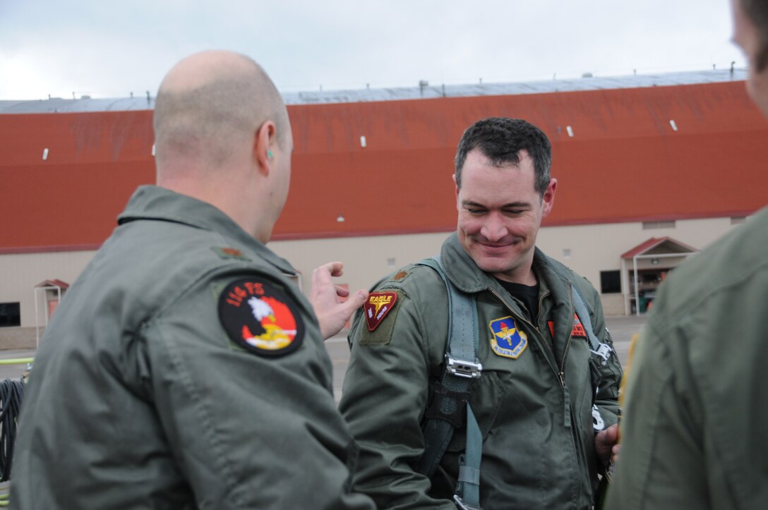 Maj. David Unruh, 173rd  Fighter Wing Instructor Pilot, places a 2,000 hour patch on the shoulder of Maj. Jeffrey Smith, 173rd Fighter Wing F-15 Instructor Pilot,  following a routine training mission that marked Smith's 2,000 hour flying the F-15 Eagle at Kingsley Field, Klamath Falls, Ore. February 12, 2010.  (U.S. Air Force photo by Tech. Sgt. Jennifer Shirar, Released)  