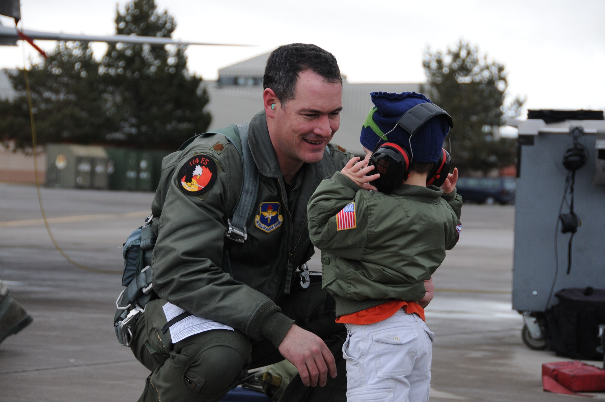 Maj. Jeffrey Smith, 173rd Fighter Wing F-15 Instructor Pilot, is greeted by his two year old son following a routine training mission that marked his 2,000 hour flying the F-15 Eagle at Kingsley Field, Klamath Falls, Ore. February 12, 2010.  (U.S. Air Force photo by Tech. Sgt. Jennifer Shirar, Released)  