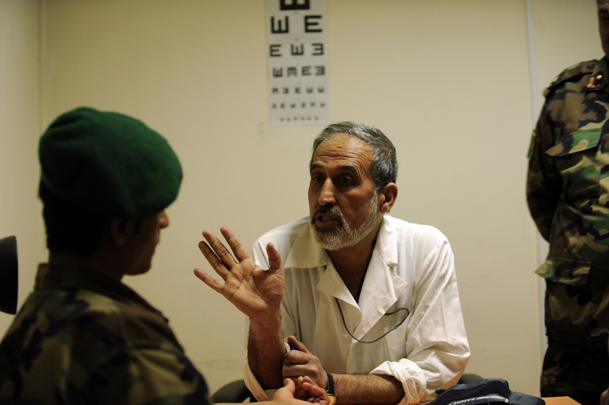 Afghan National Army Air Corps Col. Toryalay Sh-quraishee, Command Air Corps Medical Service Clinic commander, speaks with an Afghan soldier during sick-call Feb. 23, 2010, at Kabul International Airport, Afghanistan. (U.S. Air Force photo/Staff Sgt. Manuel J. Martinez/released)

