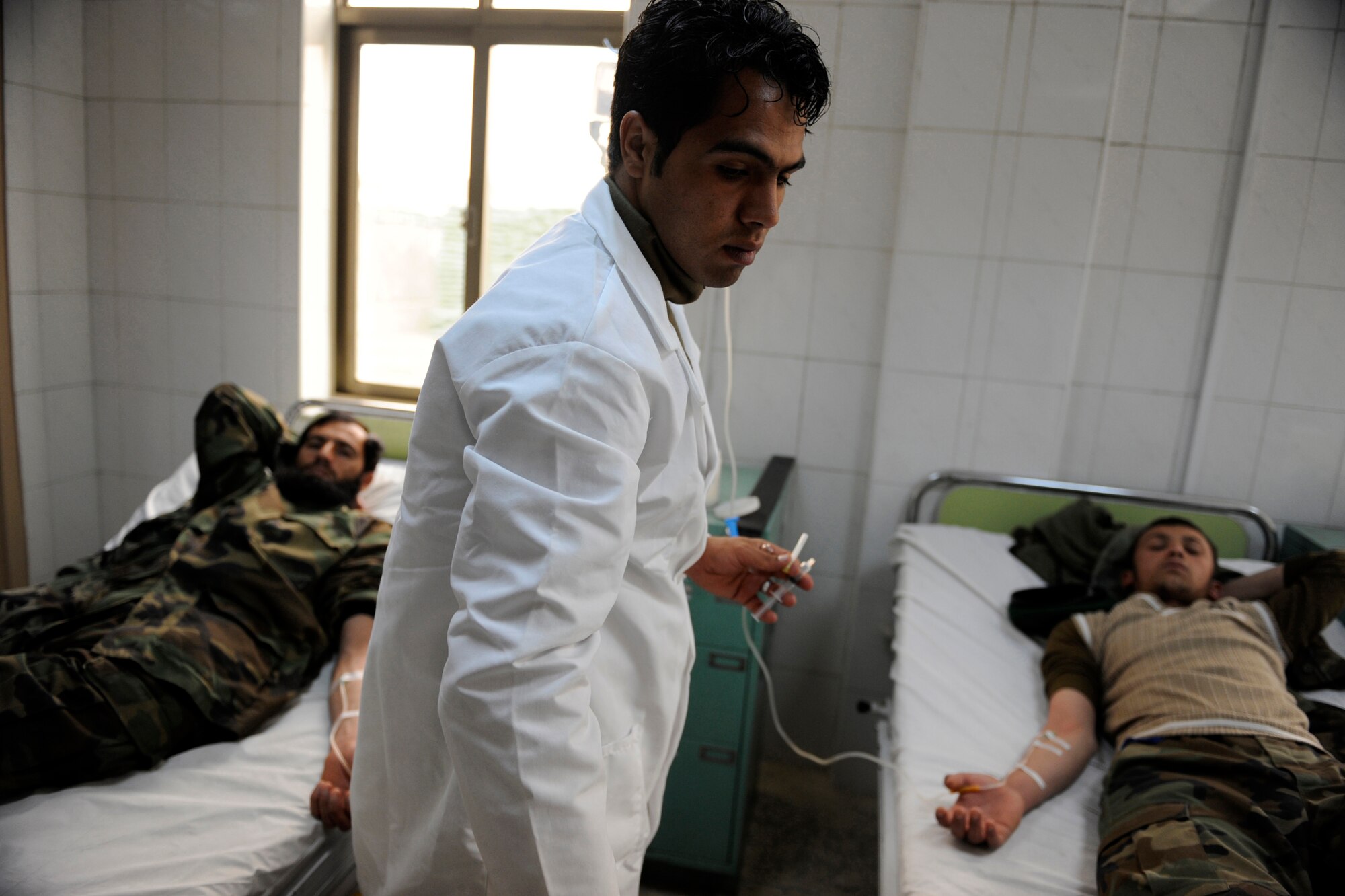 Afghan National Army Air Corps Sgt. Zabih Wafa, Command Air Corps Medical Service Clinic flight medic, cares for a dehydrated Afghan soldier Feb. 23, 2010, at Kabul International Airport, Afghanistan. (U.S. Air Force photo/Staff Sgt. Manuel J. Martinez/released)
