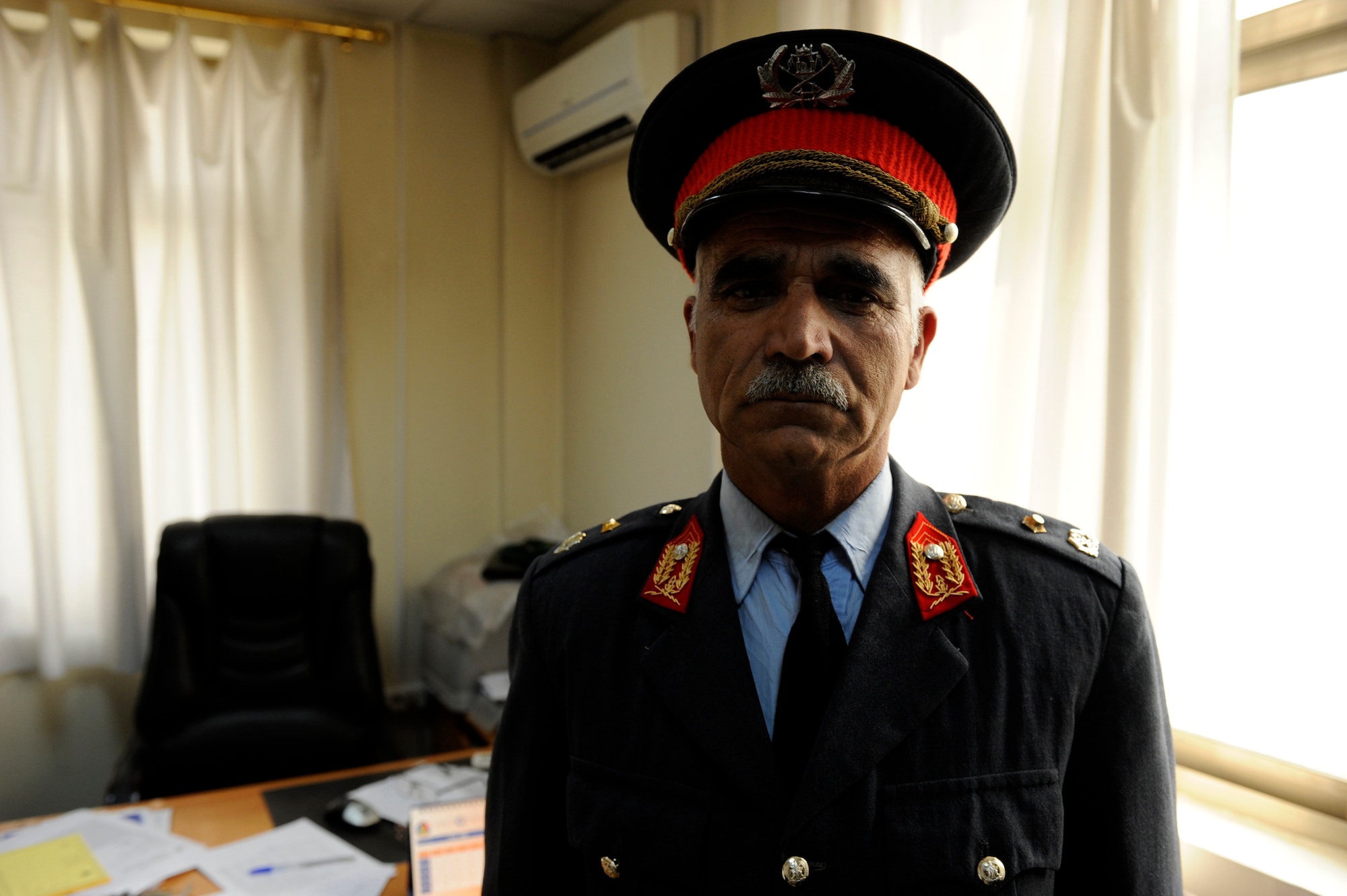 An Afghan National Army Air Corps MC-135 pilot poses for a portrait after a medical examination by Col. Toryalay Sh-quraishee, Command Air Corps Medical Service Clinic commander and flight surgeon, Feb. 23, 2010, at Kabul International Airport, Afghanistan. (U.S. Air Force photo/Staff Sgt. Manuel J. Martinez/released)
