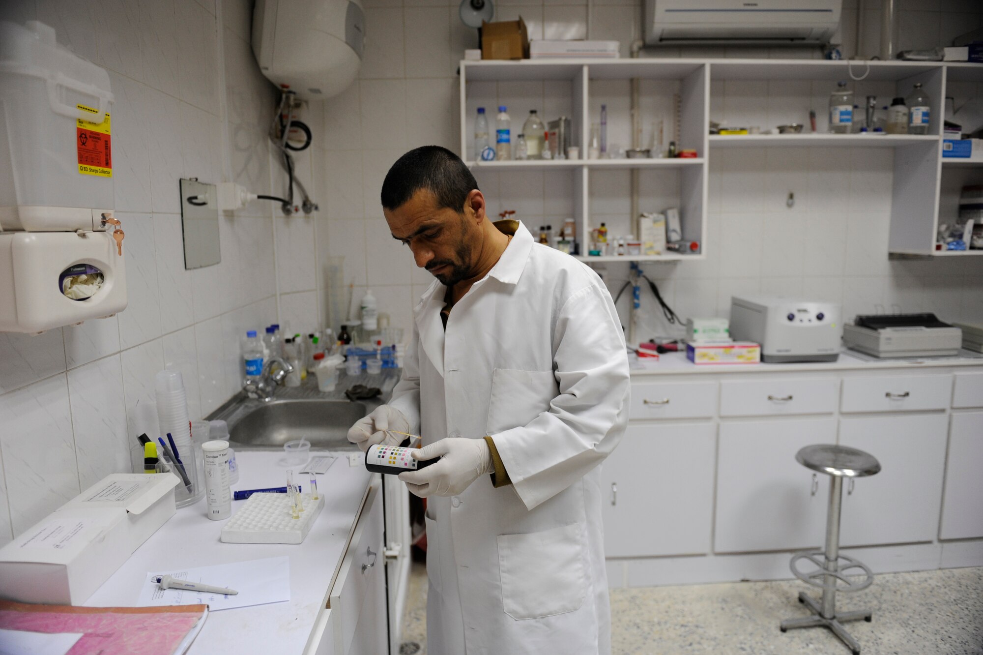 Afghan National Army Air Corps Major Ghalaam Shah, Command Air Corps Medical Service Clinic lab technician, checks results of a drug test Feb. 23, 2010, in the clinic  at Kabul International Airport, Afghanistan. (U.S. Air Force photo/Staff Sgt. Manuel J. Martinez/released)