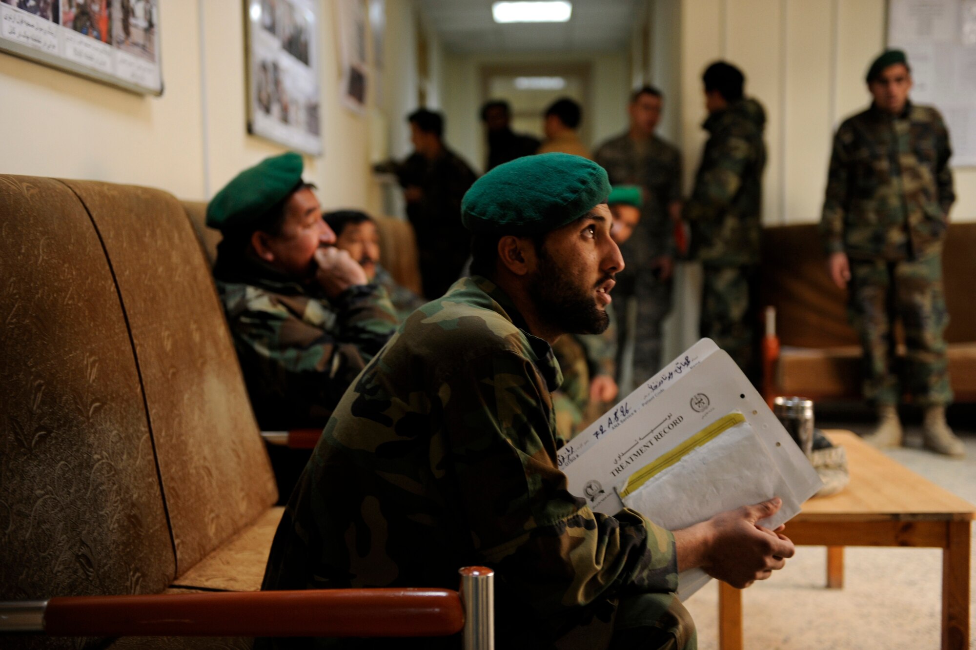 Afghan National Army Air Corps soldiers wait to be seen at the Command Air Corps Medical Service Clinic Feb. 23, 2010, at Kabul International Airport, Afghanistan. Averaging between 60 and 70 customers a week, Afghan medics treat soldiers for various medical issues. The most common being dehydration, broken bones, frost bite, work-related injuries, and dental problems and colds.  For the four-Airman medical advisory team, ensuring these Afghan medics correctly treat patients is key to getting Afghan soldiers back into the fight. (U.S. Air Force photo/Staff Sgt. Manuel J. Martinez/released)
