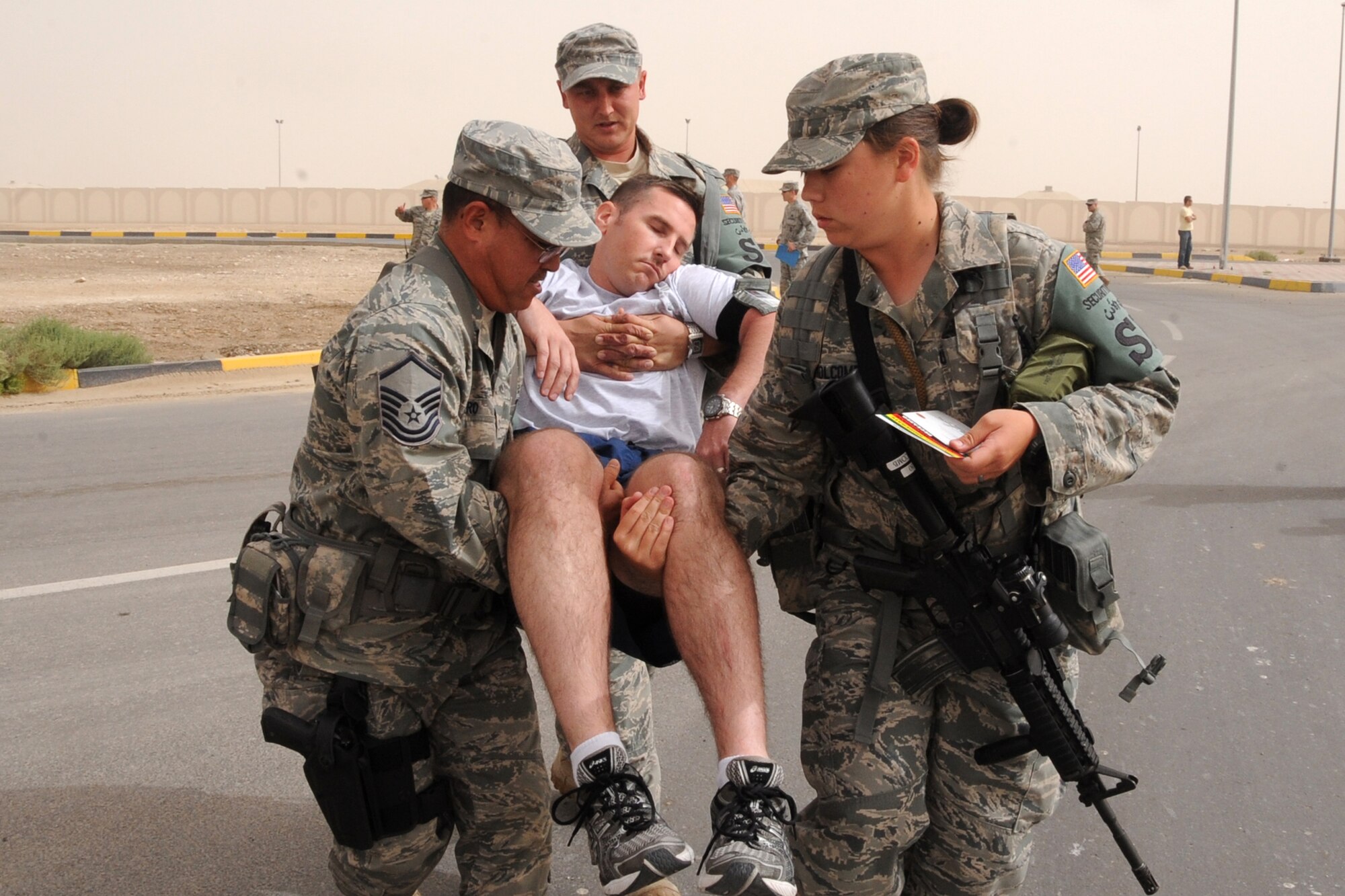 Members of the 380th Expeditionary Wing move a patient during the major accident response exercise at an undisclosed location in Southwest Aisa on March 6, 2010. Members of the 380th Air Expeditionary Wing participated in the exercise to test readiness and response to major accidents. The 380th AEW, supports Operations Iraqi Freedom and Enduring Freedom and the Combined Joint Task Force-Horn of Africa. The 380th AEW is comprised of four groups and 12 squadrons and the wing's deployed mission includes air refueling, surveillance and reconnaissance in support of overseas contingency operations in Southwest Asia. (U.S. Air Force photo/Senior Airman Jenifer H. Calhoun/Released)
