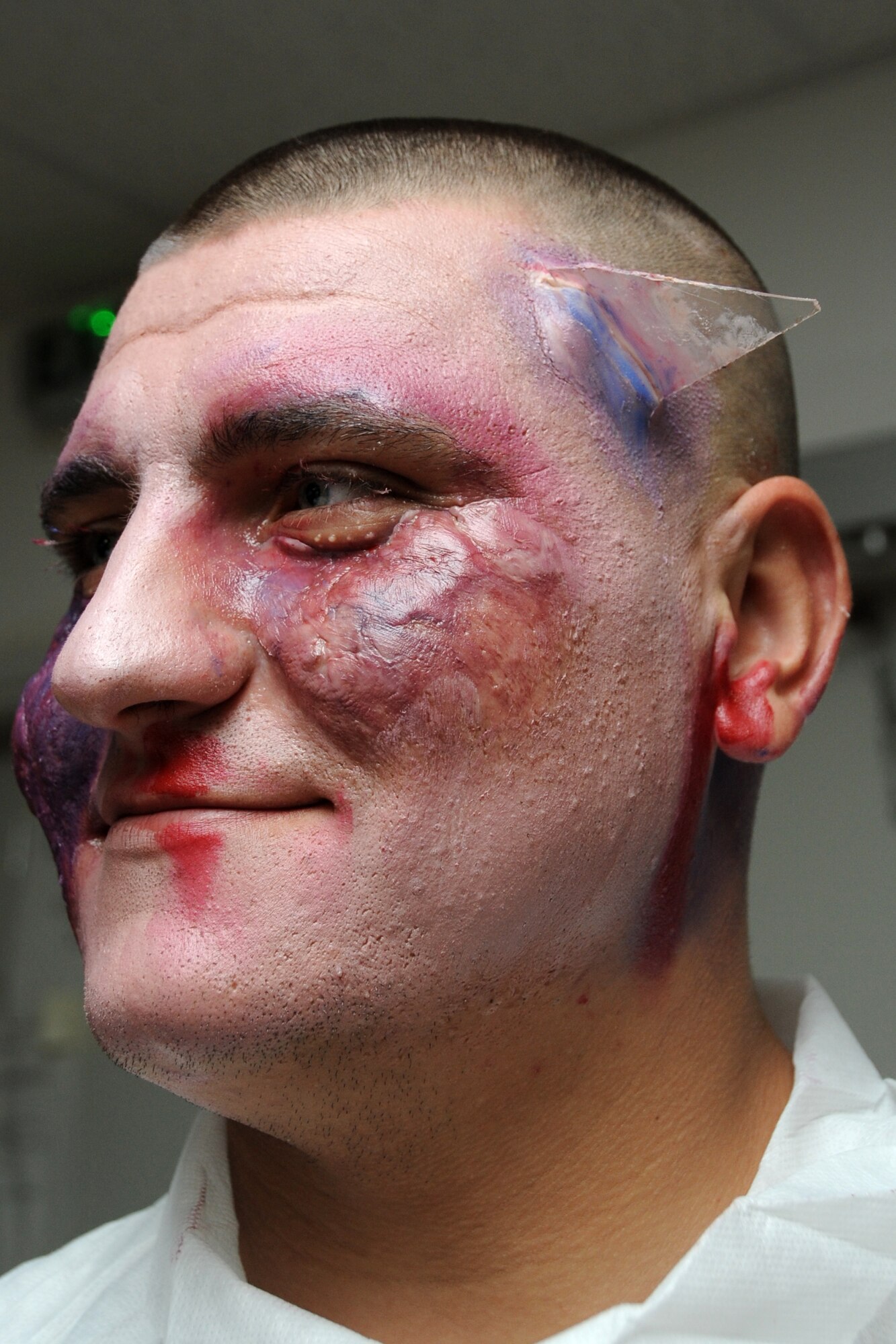 Airman 1st Class Mark Grgiyesh, 965th Expeditionary Airborne Air Control Squadron computer display technician, displays his mock injuries before participating in the major accident response exercise at an undisclosed location in Southwest Aisa on March 6, 2010. Members of the 380th Air Expeditionary Wing participated in the exercise to test readiness and response to major accidents. The 380th AEW, supports Operations Iraqi Freedom and Enduring Freedom and the Combined Joint Task Force-Horn of Africa. The 380th AEW is comprised of four groups and 12 squadrons and the wing's deployed mission includes air refueling, surveillance and reconnaissance in support of overseas contingency operations in Southwest Asia. (U.S. Air Force photo/Senior Airman Jenifer H. Calhoun/Released)
