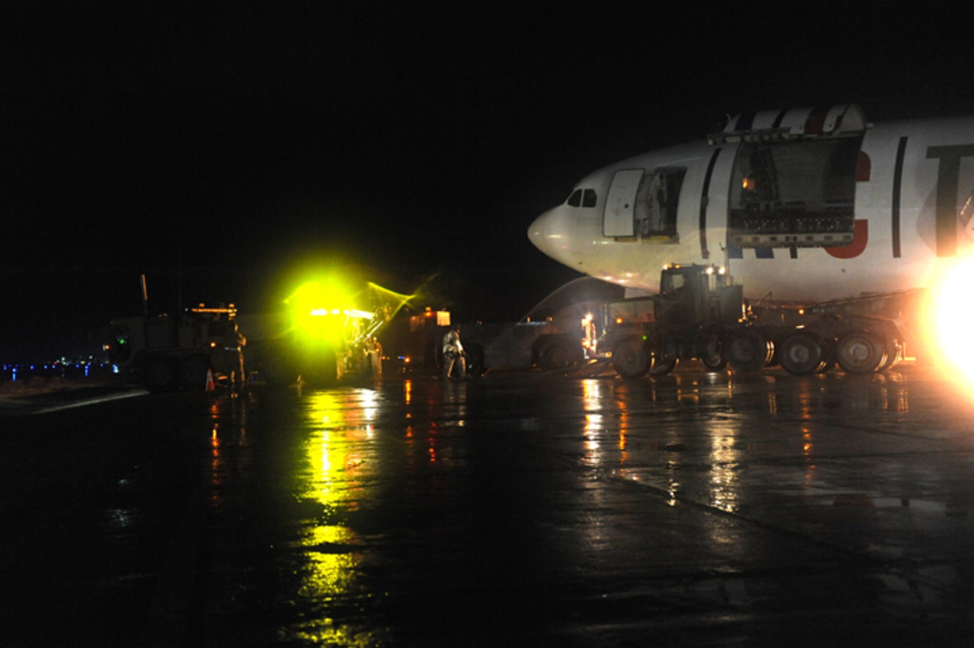 March 3, 2010, U.S. Air Force Airmen, Army Soldiers, and contractors move an Airbus A300 after its crew preformed an emergency landing at Bagram Airfield, Afghanistan, two days prior. (U.S. Air Force photo by/ Tech. Sgt. Jeromy K. Cross/released)