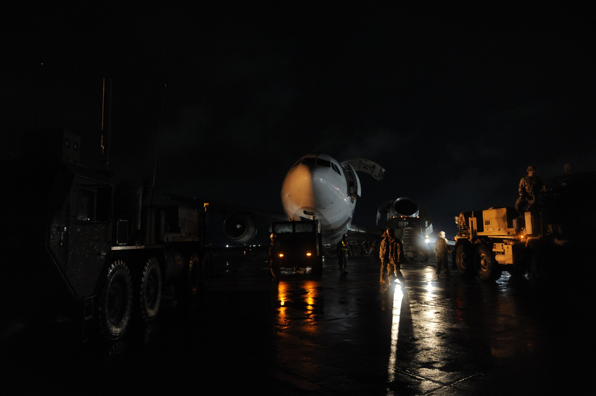 March 3, 2010, U.S. Air Force Airmen, Army Soldiers, and contractors move an Airbus A300 after its crew preformed an emergency landing at Bagram Airfield, Afghanistan, two days prior. (U.S. Air Force photo by/ Tech. Sgt. Jeromy K. Cross/released)