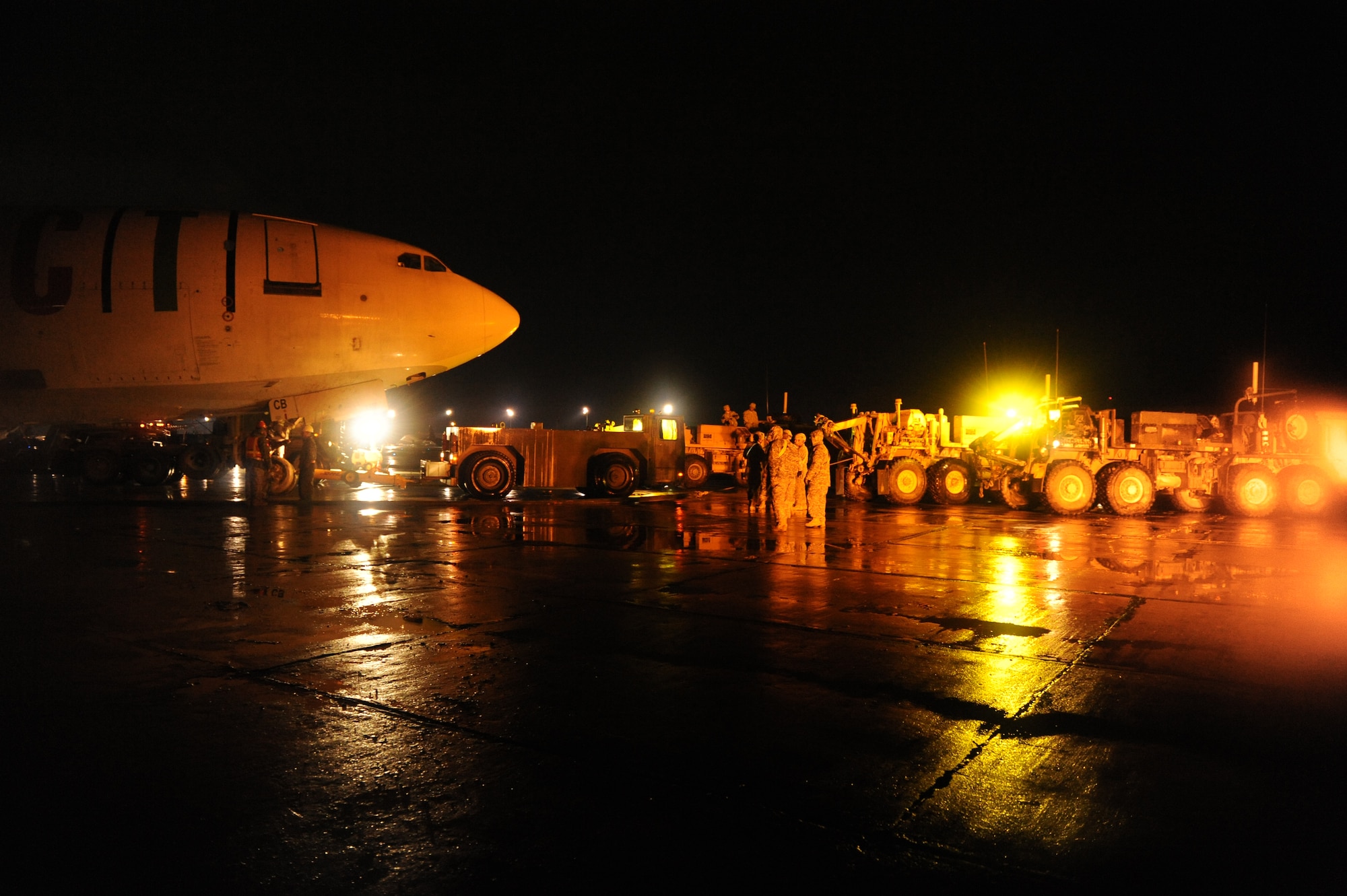 March 3, 2010, U.S. Air Force Airmen, Army Soldiers, and contractors move an Airbus A300 after its crew preformed an emergency landing at Bagram Airfield, Afghanistan, two days prior. (U.S. Air Force photo by/ Tech. Sgt. Jeromy K. Cross/released)