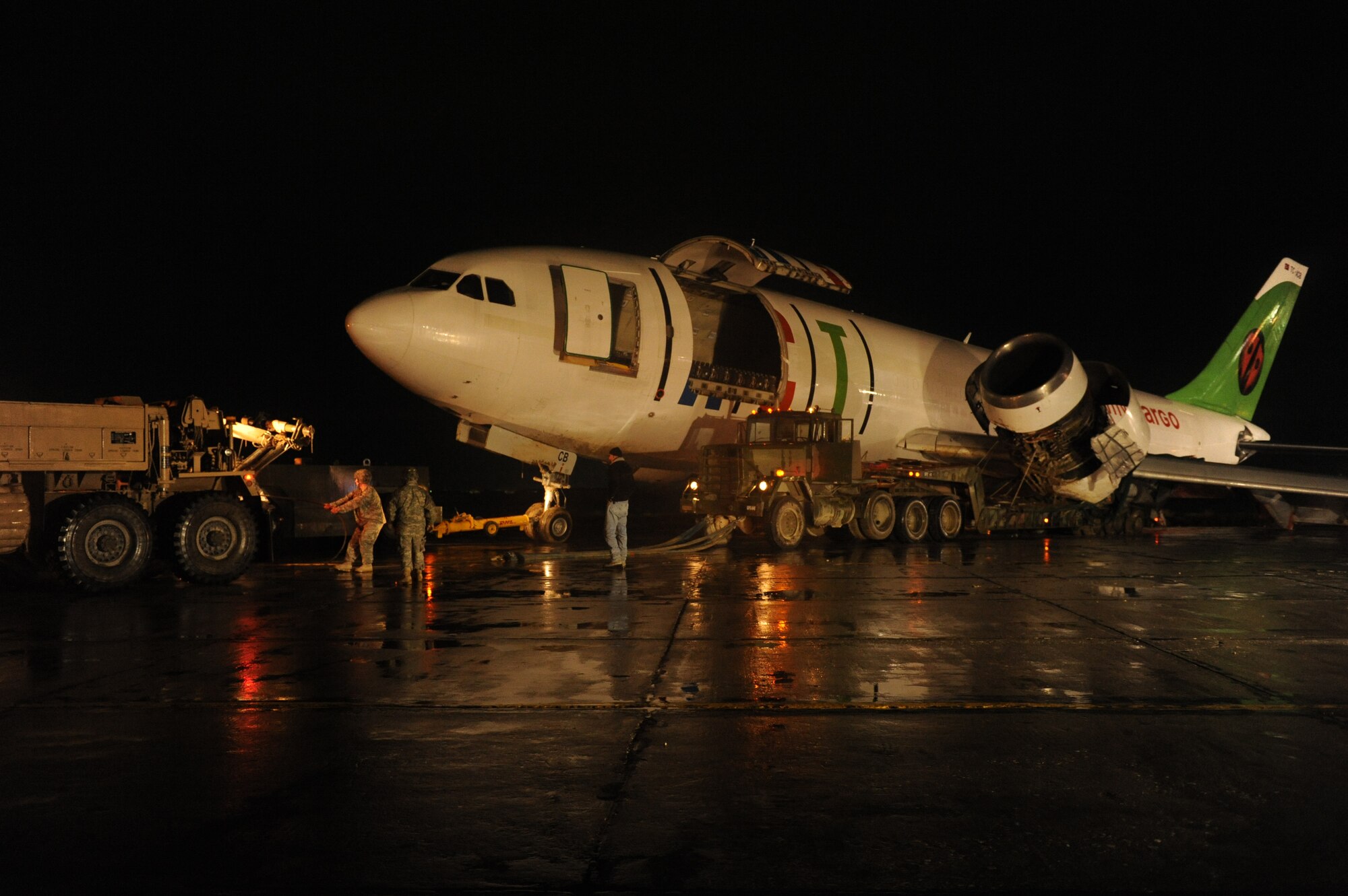 March 3, 2010, U.S. Air Force Airmen, Army Soldiers, and contractors move an Airbus A300 after its crew preformed an emergency landing at Bagram Airfield, Afghanistan, two days prior. (U.S. Air Force photo by/ Tech. Sgt. Jeromy K. Cross/released)