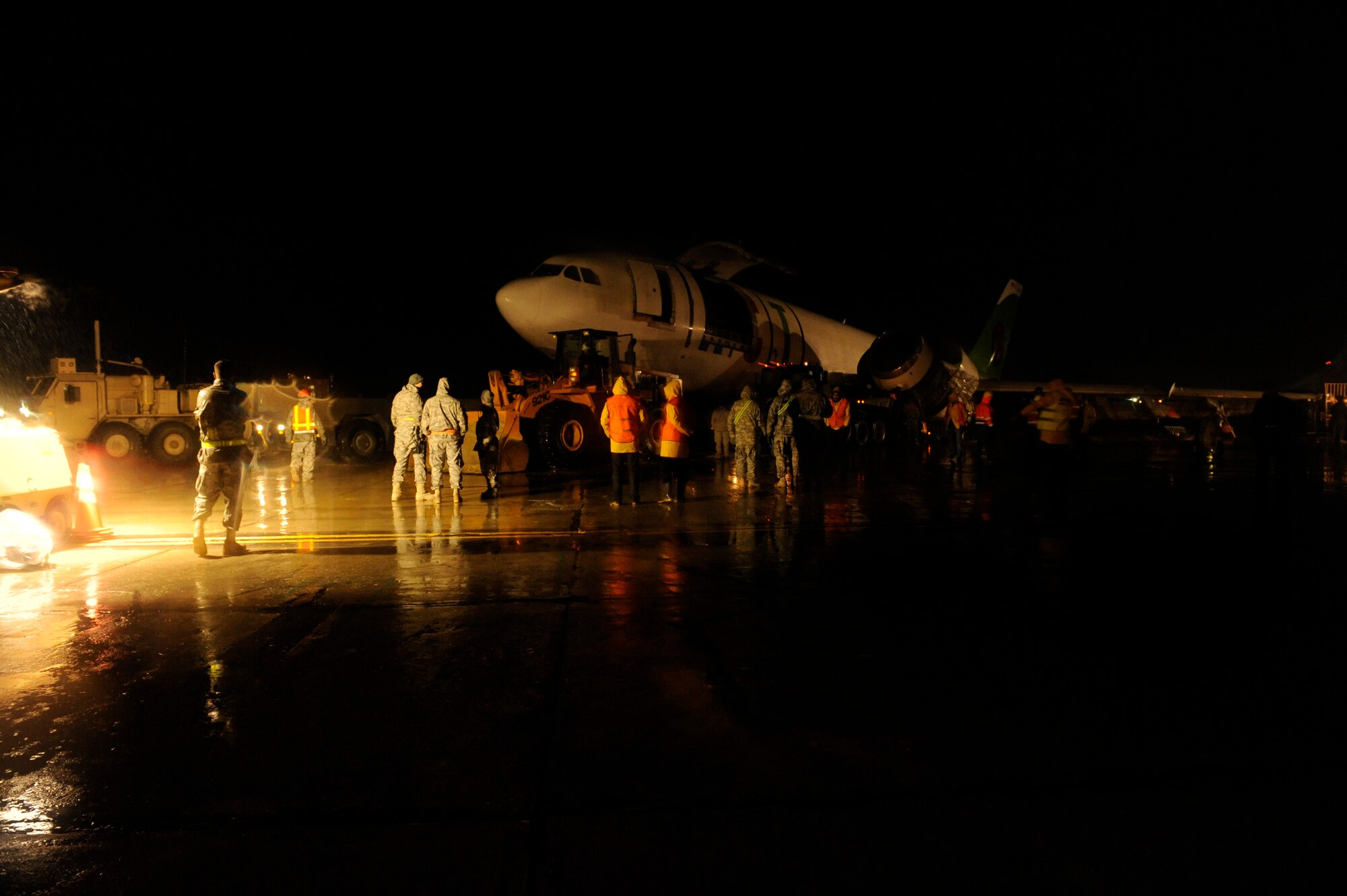 March 3, 2010, U.S. Air Force Airmen, Army Soldiers, and contractors move an Airbus A300 after its crew preformed an emergency landing at Bagram Airfield, Afghanistan, two days prior. (U.S. Air Force photo by/ Tech. Sgt. Jeromy K. Cross/released)