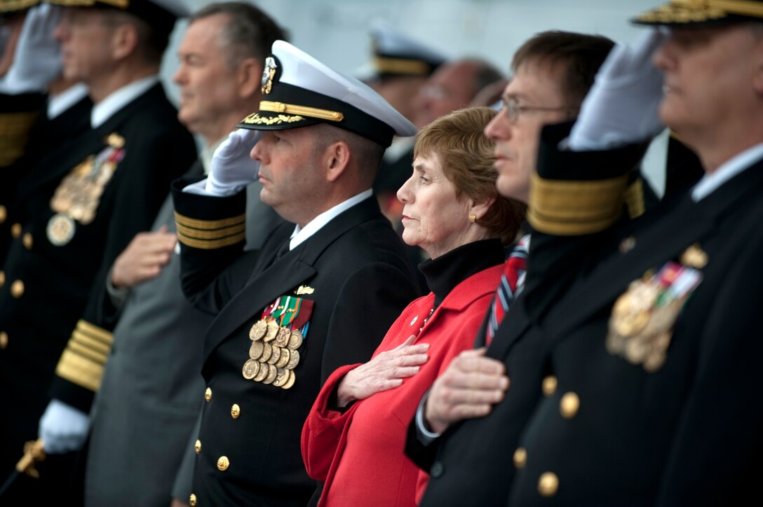 Deborah Mullen, USS Dewey ship's sponsor, renders honors with the official party at the commissioning ceremony for the U.S. Navy's newest Arleigh Burke-class guided missile destroyer at Seal Beach Naval Weapons Station, Calif., March 6, 2010. DoD photo by Navy Petty Officer 1st Class Chad J. McNeeley