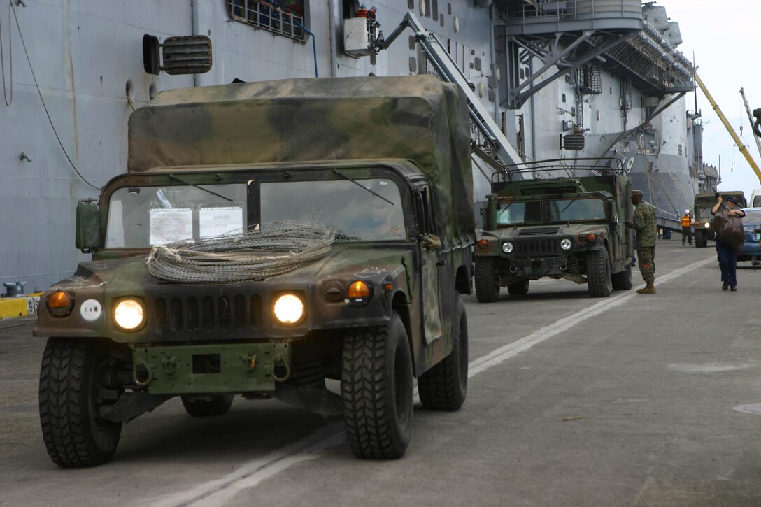 Humvees are disembarked from the forward-deployed amphibious assault ship USS Essex (LHD 2) during the 31st Marine Expeditionary Unit’s (MEU) offload phase in support of Balikatan 2010 (BK ’10), March 6 - 7. Armed Forces of the Philippines (AFP) and the U.S. are working together during BK ’10 to hone their civil-military interoperability skills to ensure more responsive, efficient and effective relief efforts. (Official Marine Corps photo by Cpl. Michael A. Bianco)