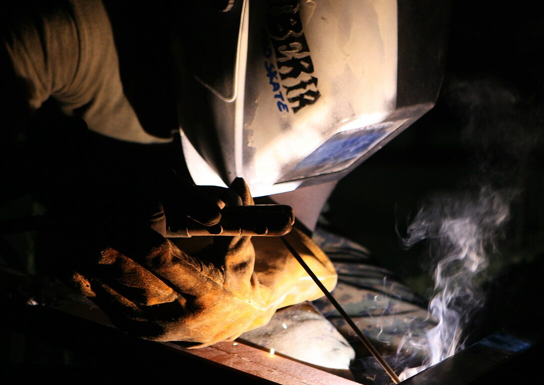 Lance Cpl. Lansana J. Kiazolu, a metal working specialist with Combat Logistics Battalion 31 (CLB-31), 31st Marine Expeditionary Unit (MEU), welds a truss to a support beam atop a roof during a renovation of a two-room classroom in support of exercise Balikatan 2010 (BK ’10), March 7. Servicemembers from the Armed Forces of the Philippines (AFP) and the 31st MEU are training together during BK ’10 to hone their civil-military interoperability skills to ensure more responsive, efficient and effective relief efforts.