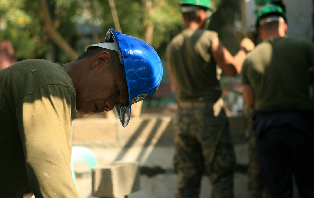 Staff Sgt. Edgardo Paycana, a carpenter with Engineering Landing Support Company (ELSC), Service Support Battalion (SSB), Philippine Marine Corps (PMC), finishes a window panel during a renovation of a two-classroom building in support of exercise Balikatan 2010 (BK ’10), March 7. Servicemembers from the Armed Forces of the Philippines (AFP) and the 31st MEU are training together during BK ’10 to hone their civil-military interoperability skills to ensure more responsive, efficient and effective relief efforts.