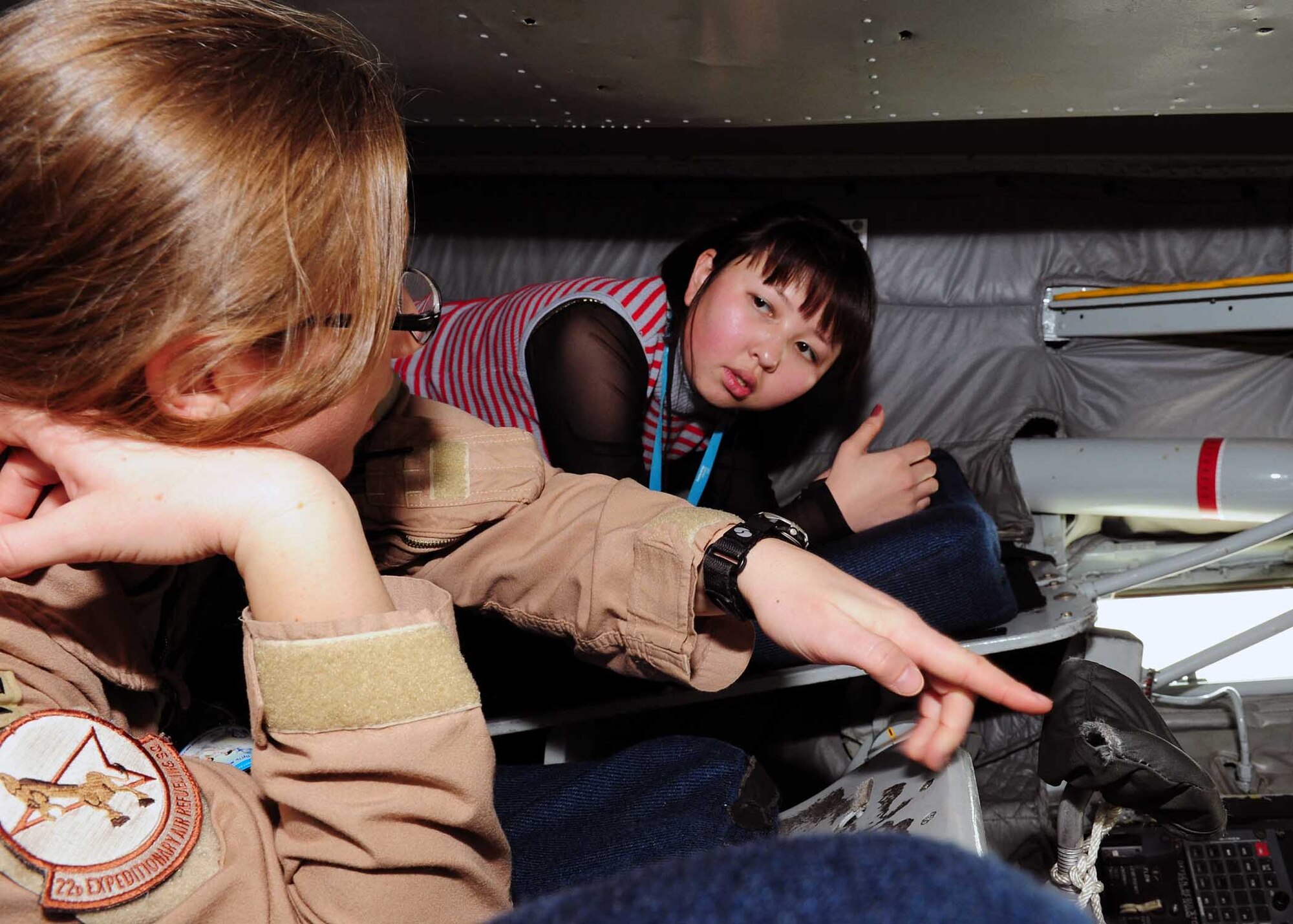 Capt. Melanie Barnes, a KC-135 pilot, shows a female student from the Kyrgyz Law Academy the boom operator’s position inside a Stratotanker on the flight line here March 6, 2010. The Kyrgyz Law Academy sent several of their female students to the installation, where many female Airmen briefed them on the operations here. This was planned in honor of Women’s Day, a national Kyrgyz holiday. (U.S. Air Force photo/Staff Sgt. Carolyn Viss/released)