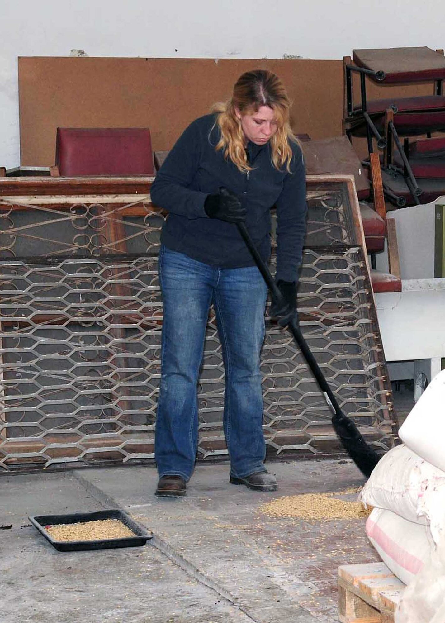 Master Sgt. Laurie Boros, 376th Air Expeditionary Wing client support administrator, sweeps the floor inside a building that will soon be renovated to become the Crisis Center for Women in Bishkek, Kyrgyzstan, March 5. Transit Center at Manas Airmen, together with the Kyrgyz Congress of Women, will help make the crisis center a place women can come for refuge. There will be a ceremony soon to officially begin the renovations.  (U.S. Air Force photo/Staff Sgt. Carolyn Viss/released)