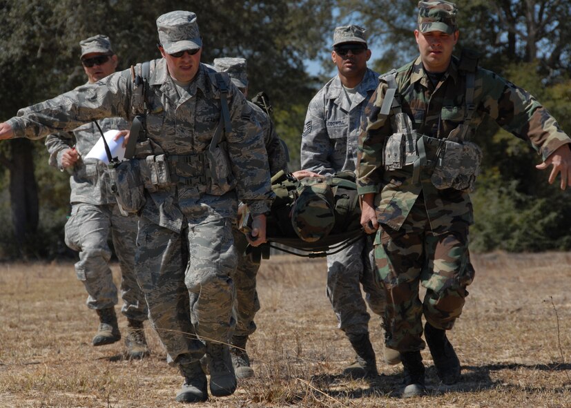 (Front to back, left to right) Airman 1st Class Chris Morie, Senior Airmen Jarod Peak, Don Brost and Tech. Sgt. John McDowell, 919th Security Forces Squadron, carry a simulated injured Airman on a litter more than 50 yards during the self-aid and buddy care scenario at Duke Field March 6.  The scenario was part of a Field Training Exercise for the 919th SFS during the UTA weekend.  Squads participated in tent building, force-on-force movements, land navigation and prisoner search.  (U.S. Air Force photo/Tech. Sgt. Samuel King Jr.) 