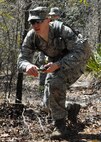 Senior Airman Zachary Mabes, 919th Security Forces Squadron, navigates his team through the dense forest of the Eglin Air Force Base range during the land navigation scenario at Duke Field March 6.  The scenario was part of a Field Training Exercise for the 919th SFS during the UTA weekend.  Squads also participated in tent building, force-on-force movements, self-aid and buddy care and prisoner search.  (U.S. Air Force photo/Tech. Sgt. Samuel King Jr.)