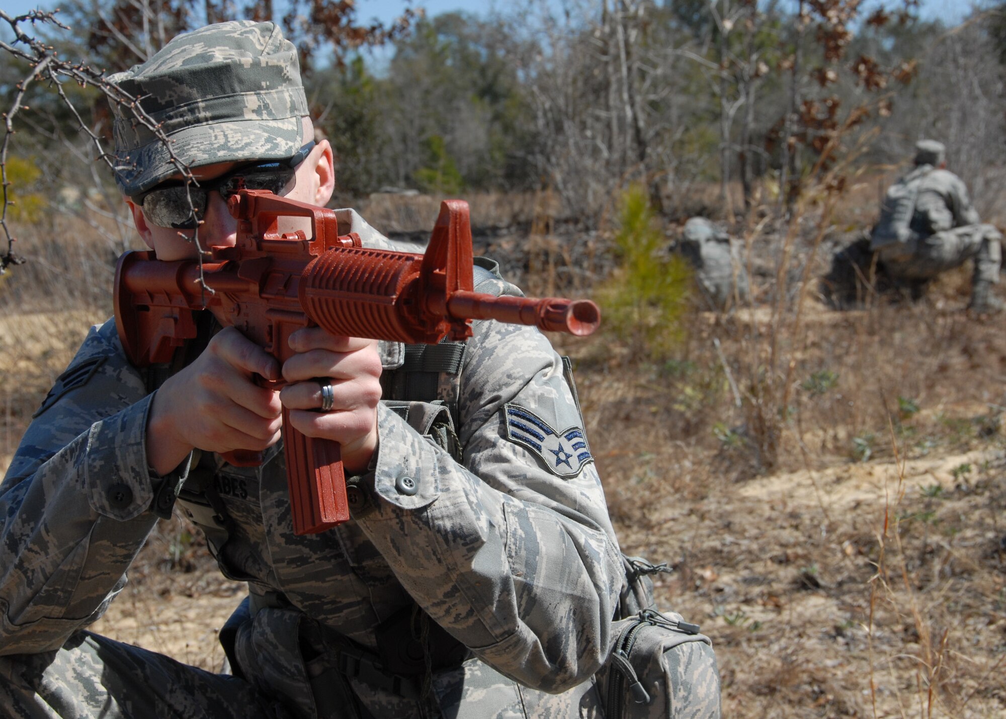 Senior Airman Zachary Mabes, 919th Security Forces Squadron, secures the south side after his squad were attacked during the force-on-force training scenario at Duke Field March 6.  The scenario was part of a Field Training Exercise for the 919th SFS during the UTA weekend.  Squads also participated in tent building, land navigation, self-aid and buddy care and prisoner search.  (U.S. Air Force photo/Tech. Sgt. Samuel King Jr.)