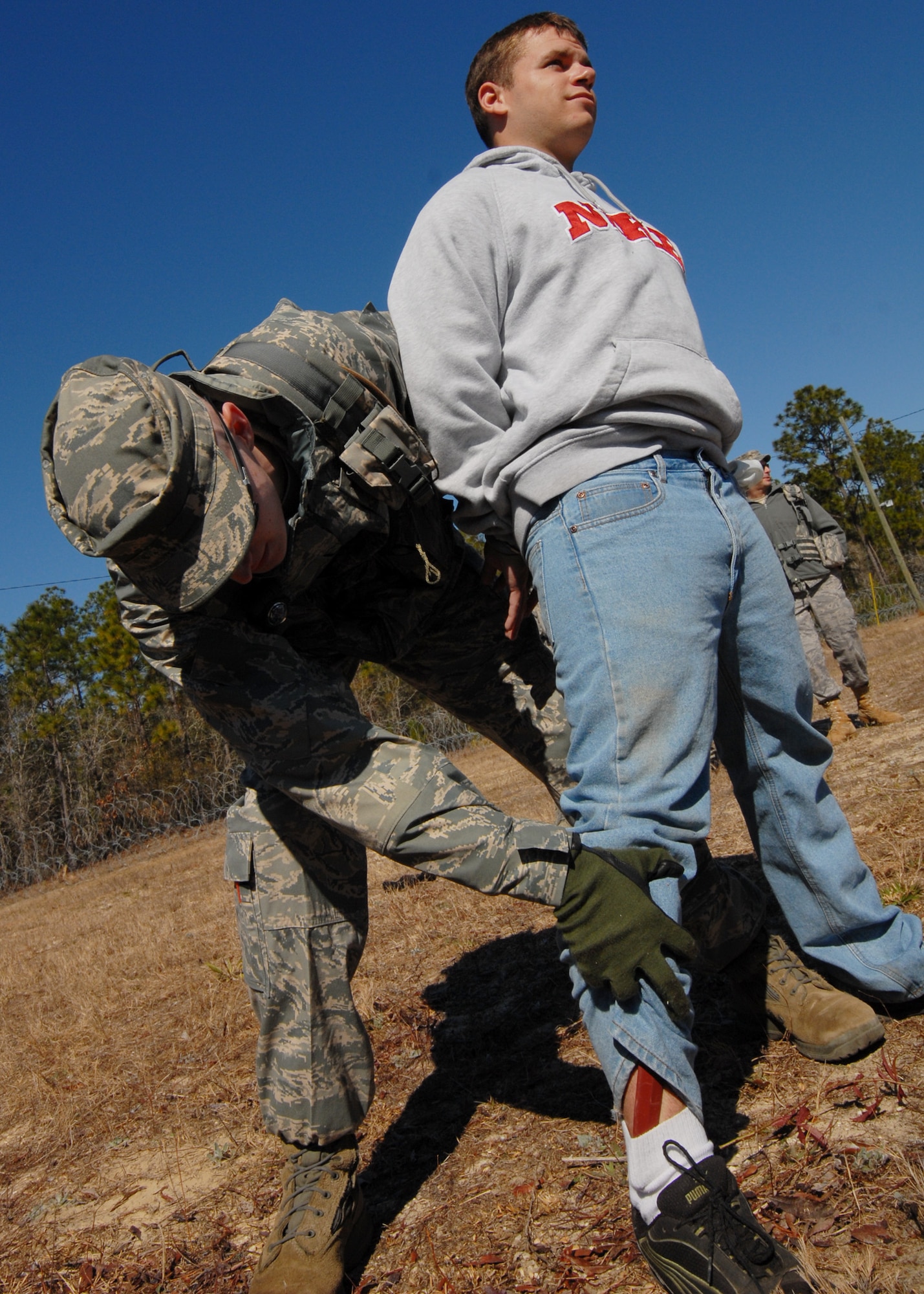 During his search, Senior Airman Zachary Mabes, 919th Security Forces Squadron, finds a knife hidden in the pants of a simulated prisoner at Duke Field March 6.  The scenario was part of a Field Training Exercise for the 919th SFS during the UTA weekend.  Squads also participated in land navigation, force-on-force movements, self-aid and buddy care and prisoner search.  (U.S. Air Force photo/Tech. Sgt. Samuel King Jr.)