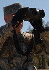 A 919th Security Forces Squadron Airman uses binoculars to find the distance during the during the land navigation scenario at Duke Field March 6.  The scenario was part of a Field Training Exercise for the 919th SFS during the UTA weekend.  Squads also participated in tent building, force-on-force movements, self-aid and buddy care and prisoner search.  (U.S. Air Force photo/Tech. Sgt. Samuel King Jr.)