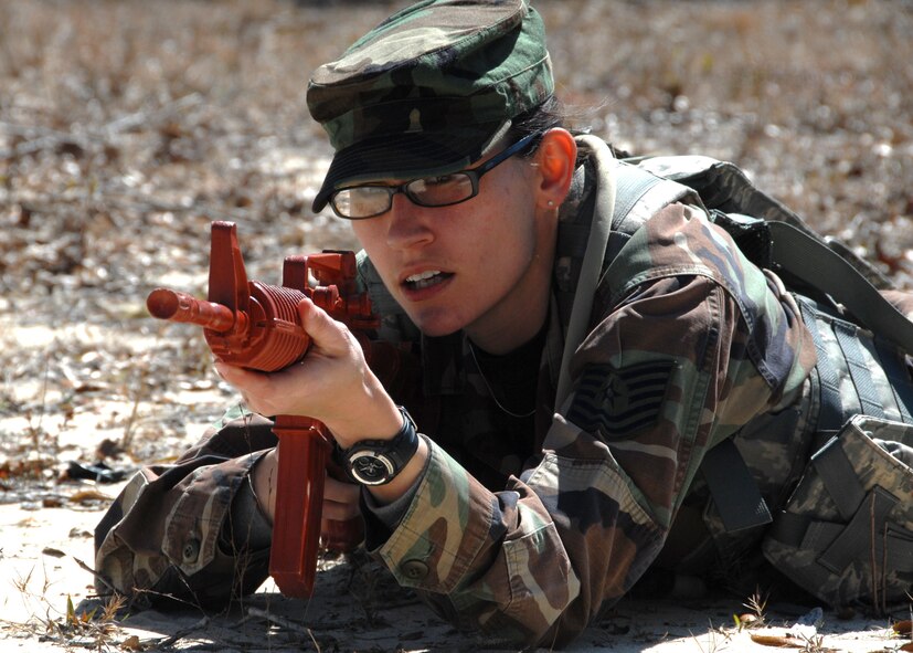 Tech. Sgt. Kay Money, 919th Security Forces Squadron, takes aim at the enemy before advancing her squad forward during the force-on-force training scenario at Duke Field March 6.  The scenario was part of a Field Training Exercise for the 919th SFS during the UTA weekend.  Squads also participated in tent building, land navigation, self-aid and buddy care and prisoner search.  (U.S. Air Force photo/Tech. Sgt. Samuel King Jr.)