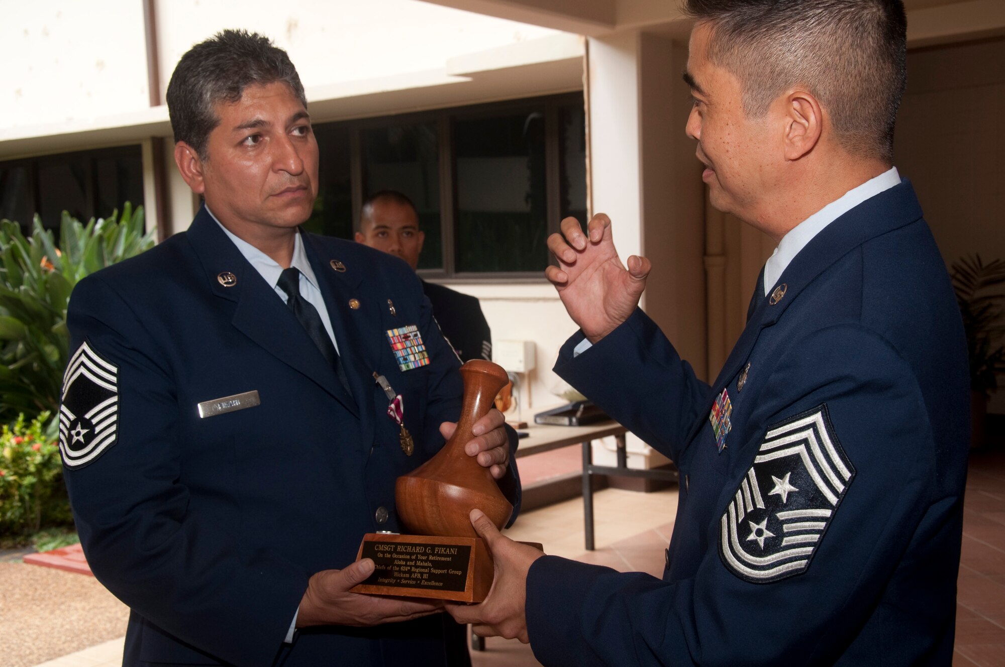 Chief Master Sgt.Brian Wong, 624th Regional Support Group command chief, left, presents Chief Master Sgt. Richard G. Fikani Jr. with an award upon his retirement from all the chiefs in the Group.

Chief Fikani began his military career by enlisting in the United States Army in December 1981. After completing nine years of active duty, he ended his Army career and settled in Honolulu, Hawaii. He then enlisted into the U.S. Air Force Reserve in November 1991 where he remained till his retirement. (U.S. Air Force photo/Master Sgt. Daniel Nathaniel)