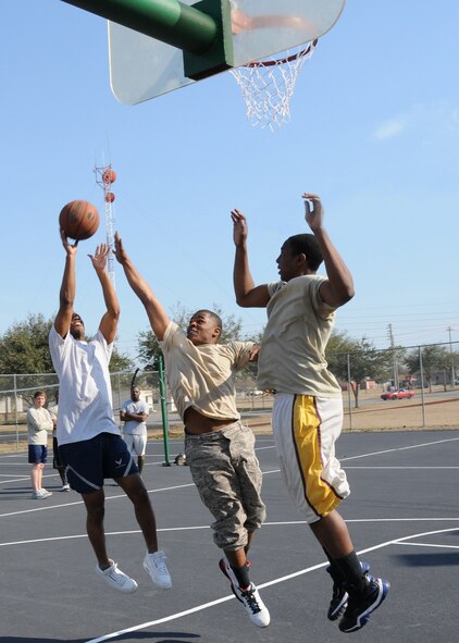 (Left to right) Quentin Moorman takes a shot against Davion Miller and David Cason during the three-on-three basketball tournament March 7 at Duke Field.  Cason’s team won two straight games in the single-elimination tournament to win.  (U.S. Air Force photo/Tech. Sgt. Samuel King Jr.)