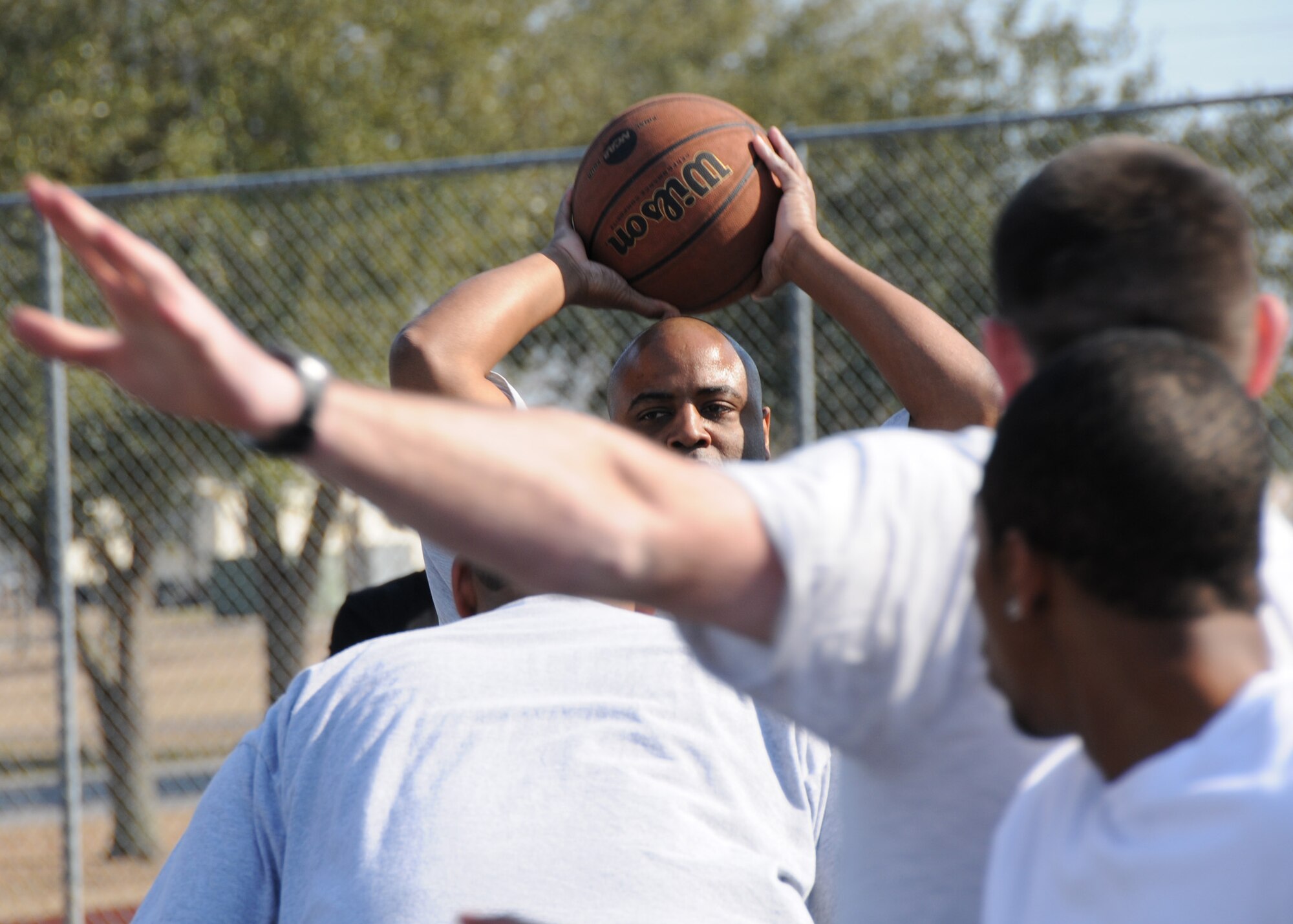 A player searches for a team member to pass to during the three-on-three basketball tournament March 7 at Duke Field.  The winning team won two straight games in the single-elimination tournament.  (U.S. Air Force photo/Tech. Sgt. Samuel King Jr.)  