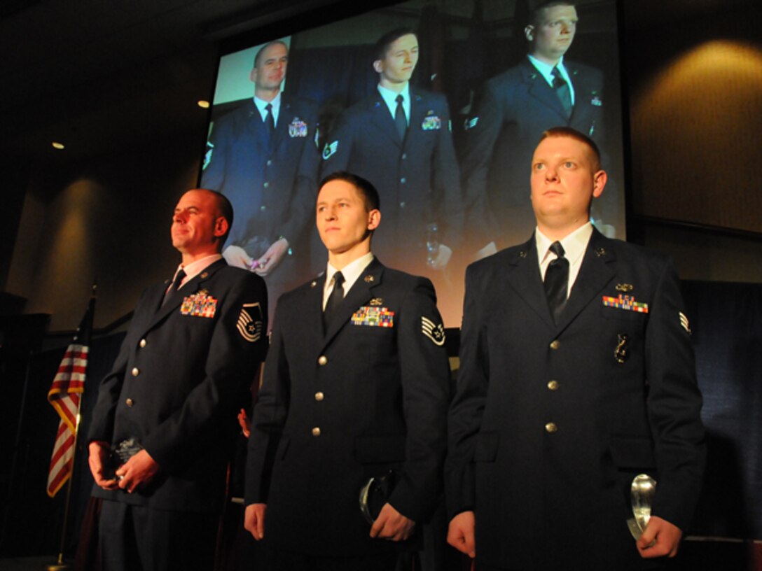 Master Sgt. Shane J. Amundson, Staff Sgt. Wesley J. Heit and Senior Airman Erik R. Foss stand on stage during the Outstanding Airman of the Year Banquet for the 119th Wing, North Dakota Air National Guard that took place on Saturday, March 6, 2010.  Amundson received the honor of Senior Non-Commissioned Officer of the Year, Heit received the honor of Commissioned Officer of the Year and Foss received the honor of Airman of the Year.