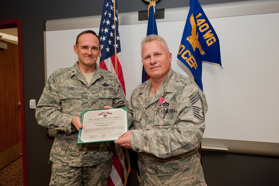 Brig. Gen. Trulan A. Eyre, 140th Wing Commander, and Chief Master Sgt. James K. Martin, 240th Civil Engineering  chief construction superintendent of Task Force Castle, pose for a photograph following a Bronze Star award ceremony at Buckley Air Force Base, Colorado Air National Guard, Jan 31, 2010. (U.S. Air Force photo/Master Sgt. John Nimmo, Sr.) (RELEASED)