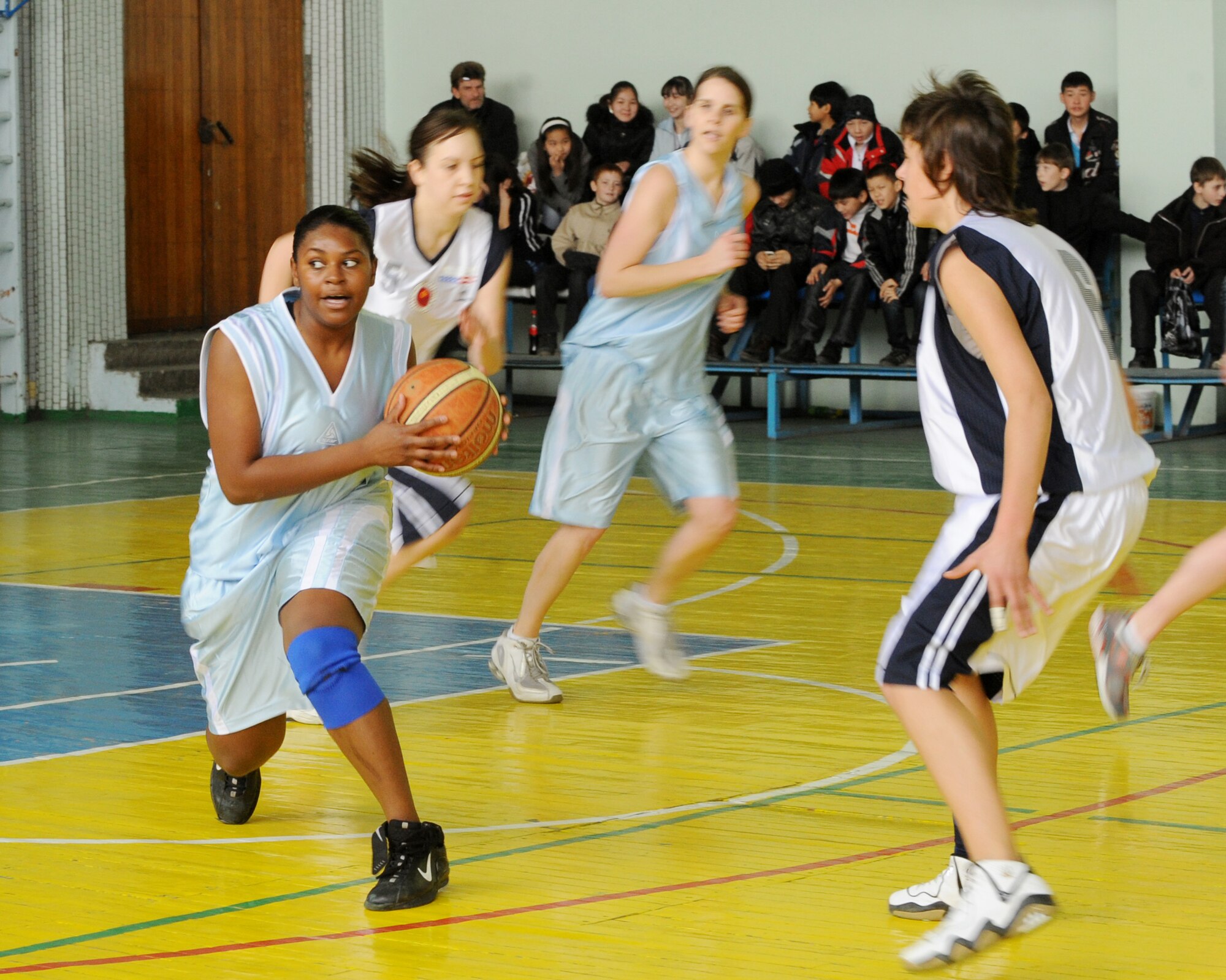 Airman 1st Class Crystal Sanders, 376th Expeditionary Civil Engineer Squadron, looks for an "open man" during a friendly game against the Technical University at the Palace of Sport in Bishkek, Kyrgyzstan March 5, 2010. This is the first women's basketball game between the Transit Center at Manas and the local Kyrgyz community. The game was hosted by the U.S. Embassy and played in honor of International Women's Day. (U.S. Air Force photo/Senior Airman Nichelle Anderson/released)
