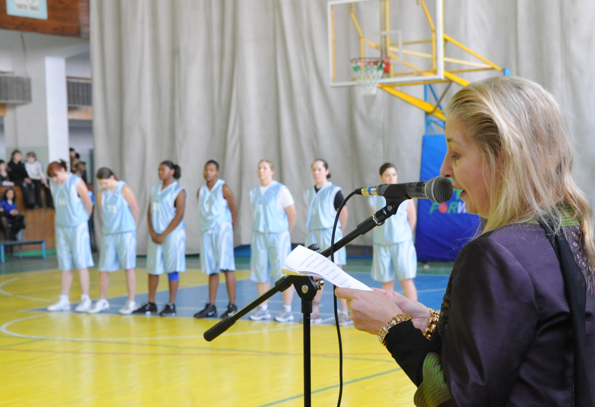 U.S. Ambassador to Kyrgyzstan, Tatiana Gfoeller, speaks during the opening ceremony for the Transit Center at Manas women's basketball game, against Technical University at the Palace of Sport in Bishkek, Kyrgyzstan, March 5, 2010. The friendly game was hosted by the U.S. Embassy and played in honor International Women's Day, which is celebrated annually on March 8.  (U.S. Air Force photo/Senior Airman Nichelle Anderson/released)
