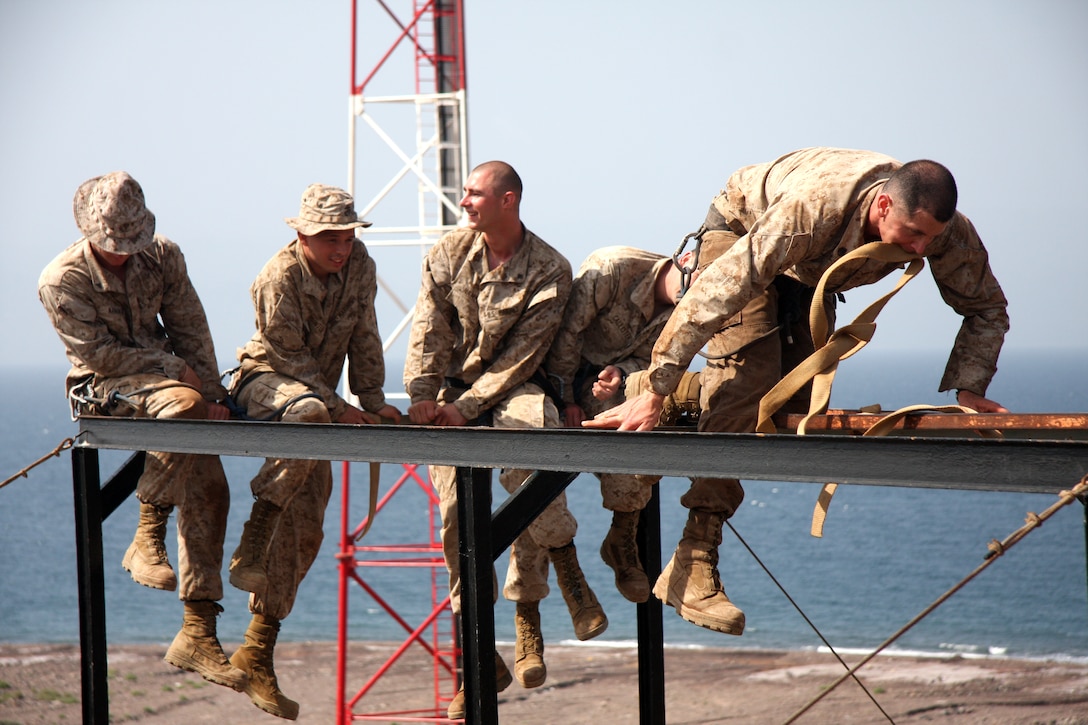 Marines of Bravo Company and Combined Anti-Armor Team, Battalion Landing Team 1st Battalion, 9th Marine Regiment, 24th Marine Expeditionary Unit practice knot tying, repelling techqniues, and navagation through obstacles in water and mountainous terrain while training Djibouti, Africa, March 7. Due to the unique physical challenges, these Marines are part of a select few from BLT 1/9 that were chosen to be a part of this training that focuses on teamwork, strength, endurance, balance, and problem solving. (US Marine Corps photo by Sgt Andrew J Carlson)