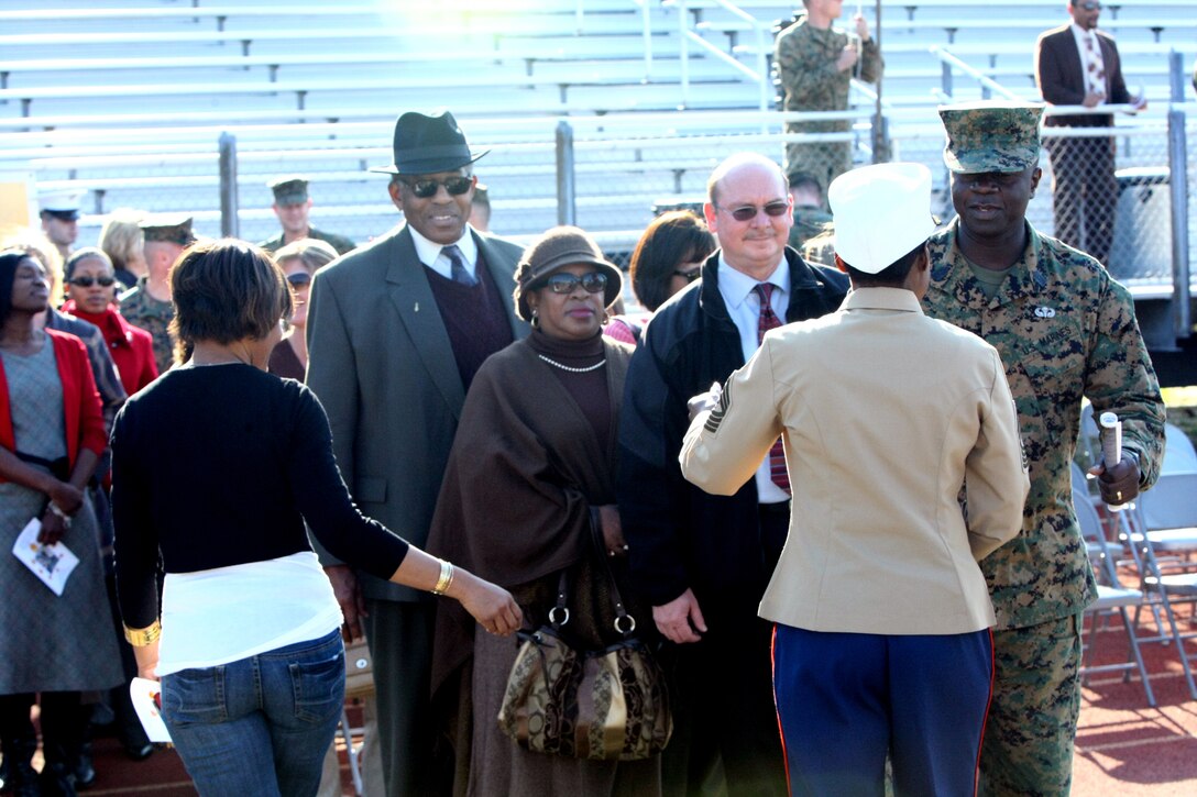 MARINE CORPS BASE CAMP LEJEUNE, N.C. – Marines, friends and family of retired Master Gunnery Sgt. Marcia McLaurin, family readiness officer with Headquarters and Support Battalion, Marine Corps Base Camp Lejeune, form a line to wish her ‘fair winds and sailing seas’ after her retirement ceremony at Liversedge Field, March 8.