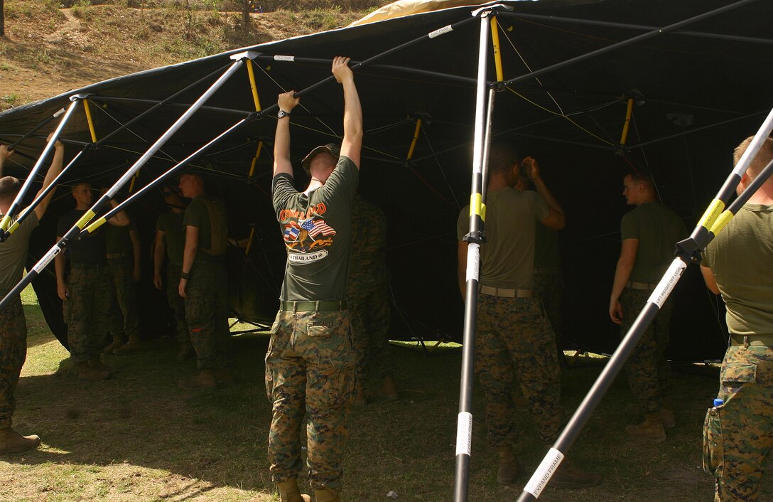 Marines and sailors with Combat Logistics Battalion 31 (CLB-31), 31st Marine Expeditionary Unit (MEU), set-up a tent during the MEU’s construction phase of camp facilities in support of Balikatan 2010 (BK ’10). Servicemembers from the Armed Forces of the Philippines (AFP) and the 31st MEU are training together during BK ’10 to hone their civil-military interoperability skills to ensure more responsive, efficient and effective relief efforts. (Official Marine Corps photo by Cpl. Michael A. Bianco)