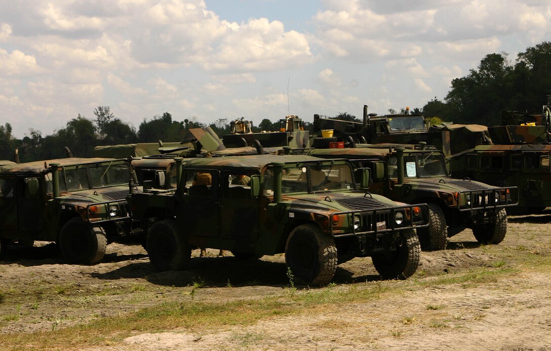 Military vehicles and construction equipment from the 31st Marine Expeditionary Unit are staged after being delivered during the MEU’s construction phase of camp facilities in support of Balikatan 2010 (BK ’10). Servicemembers from the Armed Forces of the Philippines (AFP) and the 31st MEU are training together during BK ’10 to hone their civil-military interoperability skills to ensure more responsive, efficient and effective relief efforts. (Official Marine Corps photo by Cpl. Michael A. Bianco)