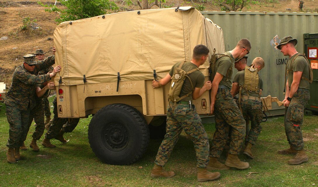 Marines and sailors with Combat Logistics Battalion 31 (CLB-31), 31st Marine Expeditionary Unit (MEU), move a trailer into place during the MEU’s construction phase of camp facilities in support of Balikatan 2010 (BK ’10). Servicemembers from the Armed Forces of the Philippines (AFP) and the 31st MEU are training together during BK ’10 to hone their civil-military interoperability skills to ensure more responsive, efficient and effective relief efforts. (Official Marine Corps photo by Cpl. Michael A. Bianco)