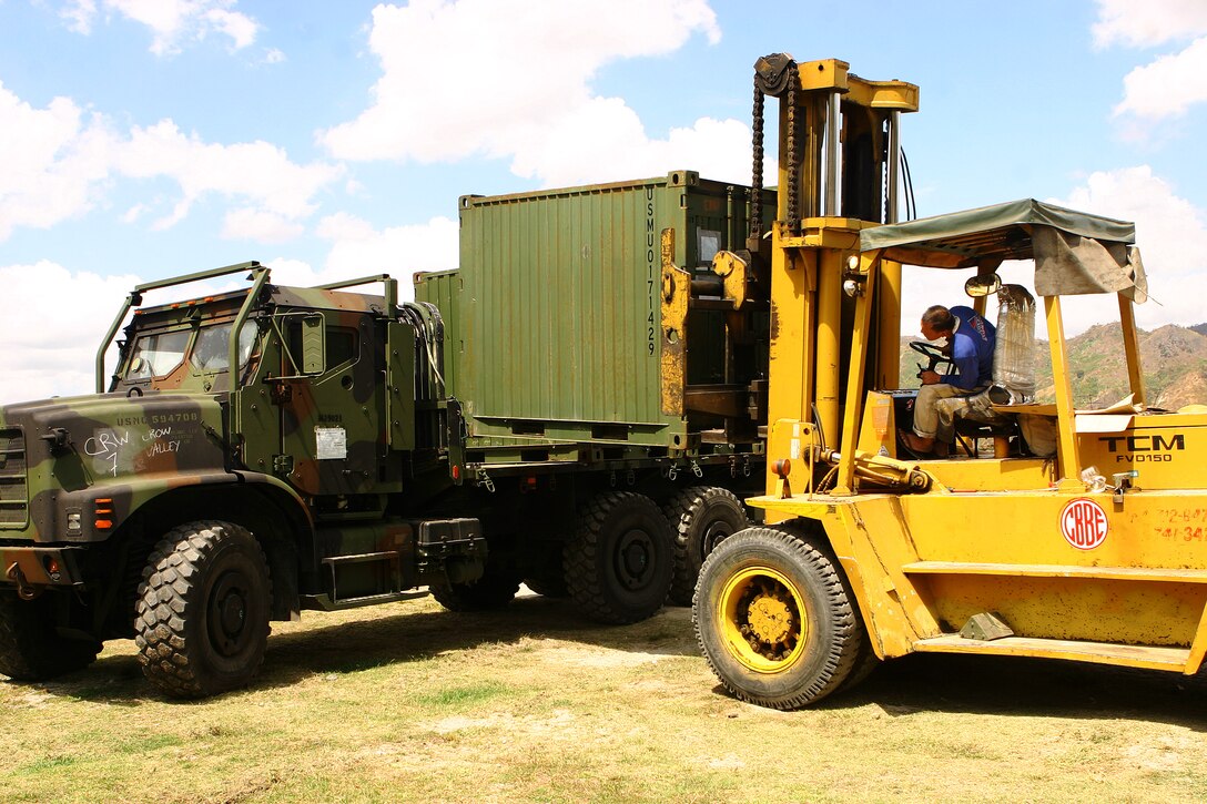Supply containers are lifted off the back of a 7-ton during the 31st Marine Expeditionary Unit’s (MEU) construction phase of camp facilities in support of Balikatan 2010 (BK ’10). Servicemembers from the Armed Forces of the Philippines (AFP) and the 31st MEU are training together during BK ’10 to hone their civil-military interoperability skills to ensure more responsive, efficient and effective relief efforts. (Official Marine Corps photo by Cpl. Michael A. Bianco)