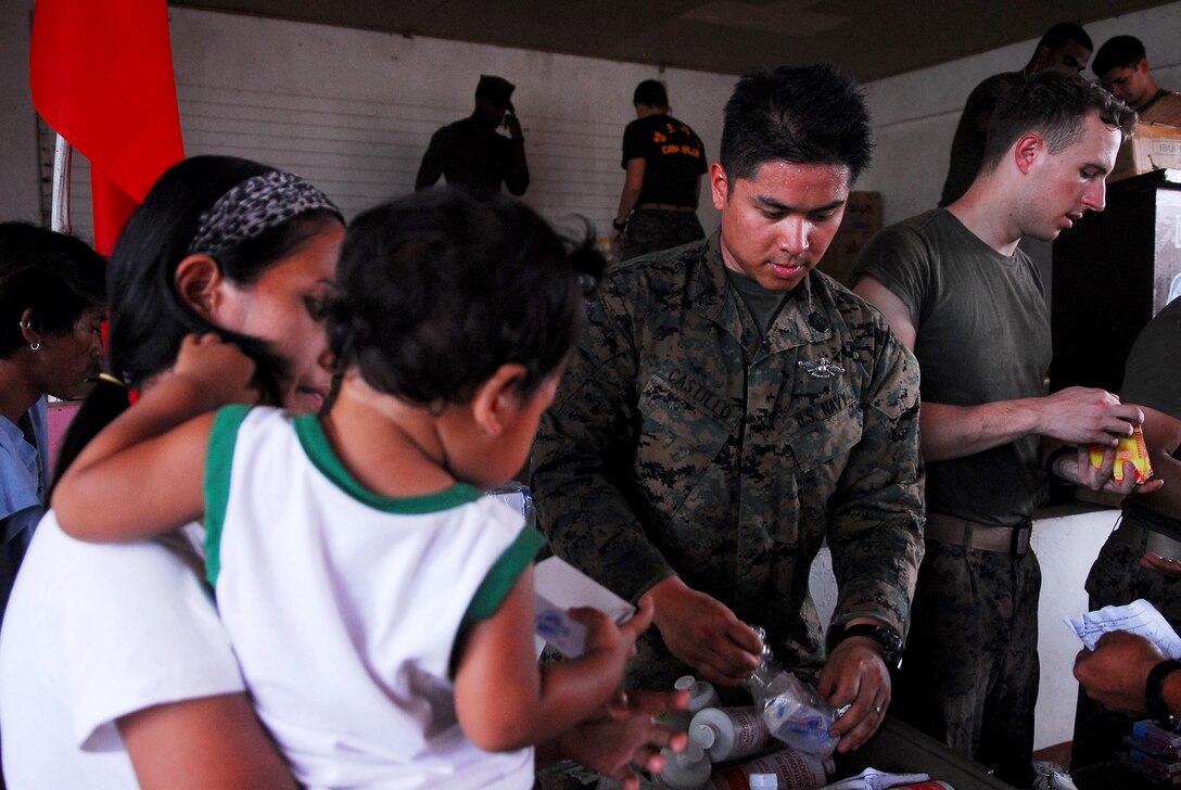 Petty Officer 2nd Class Joseph Castillo, corpsman with Combat Logistics Battalion 31 (CLB-31), 31st Marine Expeditionary Unit (MEU), hands out medication during a medical civil action project(MEDCAP) at San Juan Elementary School. The 31st MEU is operating with the forward-deployed Essex Amphibious Ready Group as part of exercise Balikatan 2010, an annual, bilateral exercise designed to improve interoperability between the U.S. and Republic of the Philippines.  (U.S. Navy Photo by Petty Officer 3rd Class Andrew Smith)