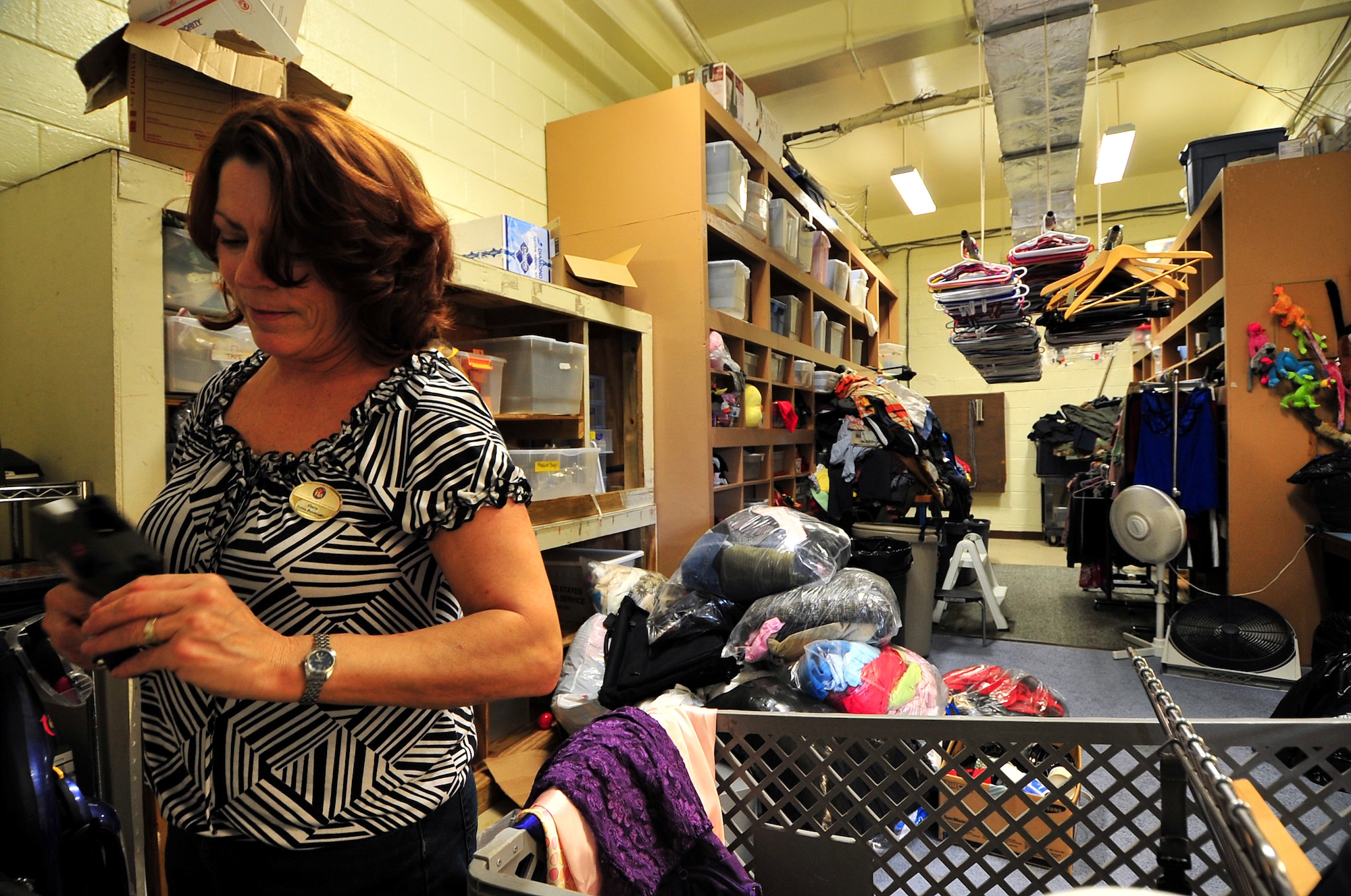 Gloria Herring, thrift store sales associate, places price tags on all the items that come in to the Okinawa Enlisted Spouses Club Thrift Store and Uncle Sam's Attic Feb. 26. OESC and USA is a non-profit organization which supports American and Japanese charitable projects and special interest groups on Okinawa. Some of their contributions in 2009 was supplying $8K worth of uniforms, boots and accessories to military members island wide; $66K to the Okinawa Enlisted Spouse Club; and 89K in toys, clothes and shoes for distribution to needy families all over the world. "The thrift store saves a lot of money for Airmen and their families to have things they couldn't afford," said Brig. Gen. Ken Wilsbach."The service provided for the Airmen is greatly appreciated."  The thrift store is asking for volunteers to help continue the success of the group and its mission.(U.S. Air Force photo/Tech. Sgt. Rey Ramon)                                        