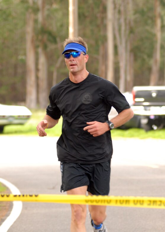 VANDENBERG AIR FORCE BASE, Calif. - - As the first runner to complete the Guardian Challenge 5K Run, Maj. Jon Mason, of the 30th Weather Squadron, breaks the tape at the finish line here Friday, March 5, 2010. (U.S. Air Force photo/Airman 1st Class Kerelin Molina)