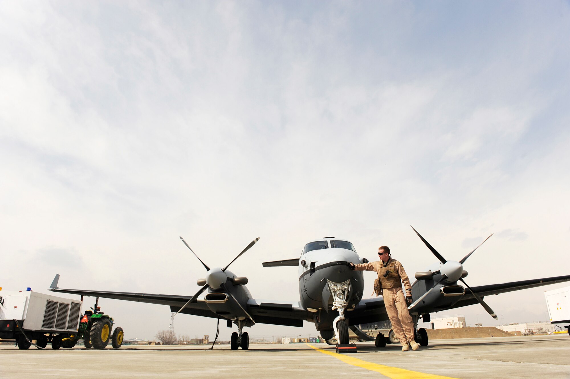 Lt. Col. Douglas J. Lee, the commander of the 4th Expeditionary Reconnaissance Squadron at Bagram Airfield, Afghanistan, performs a walk-around inspection of an MC-12 Liberty Feb. 27, 2010, prior to a mission.  A four-person aircrew flies the modified King Air 350 commercial plane to provide real-time full-motion video and signals information to help military leaders make battlefield decisions.(U.S. Air Force photo/Staff Sgt. Manuel J. Martinez)